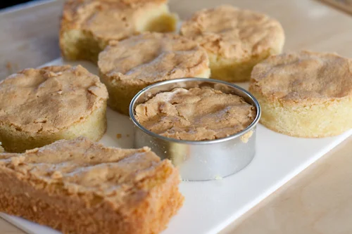 Cutting rounds of almond cake with pastry cutters