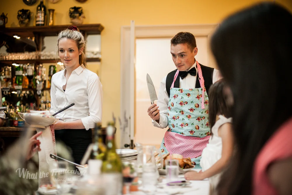Our designated chicken carver. Each table was giving a gigantic roasted bird for dinner. One lucky gent from each table was given an apron and carving responsibilities.