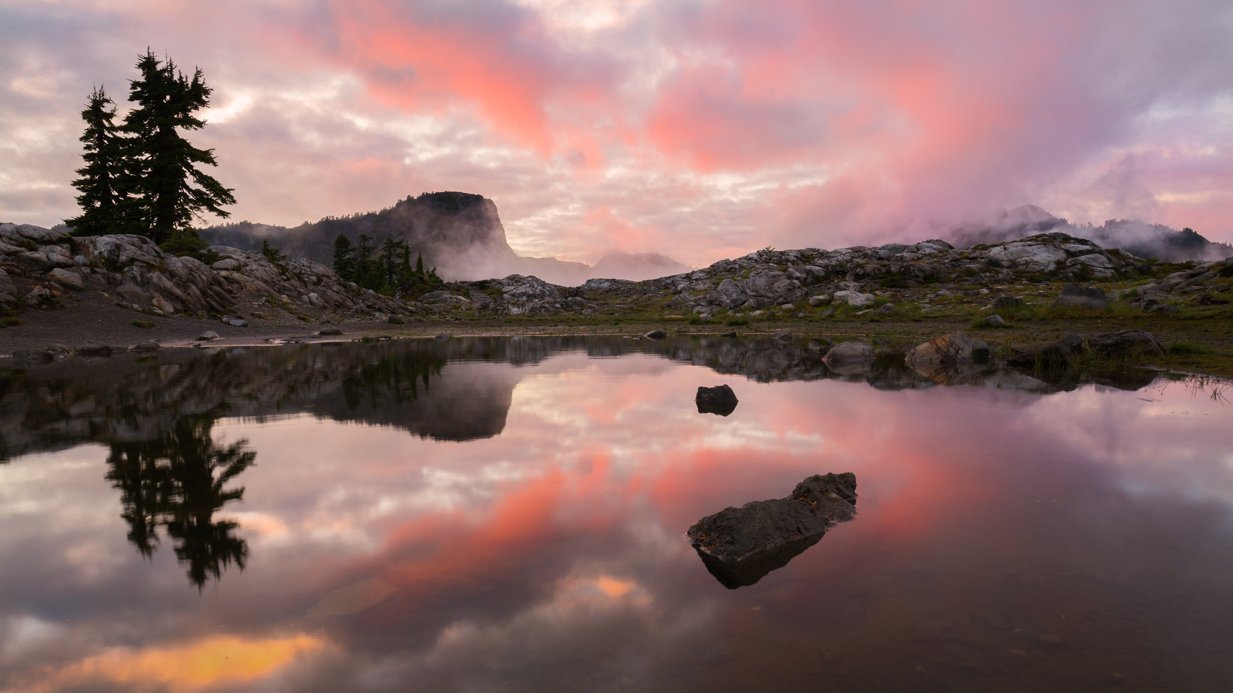  Looking east across a pond as the sun lights up the sky at sunset near Artist Point. 