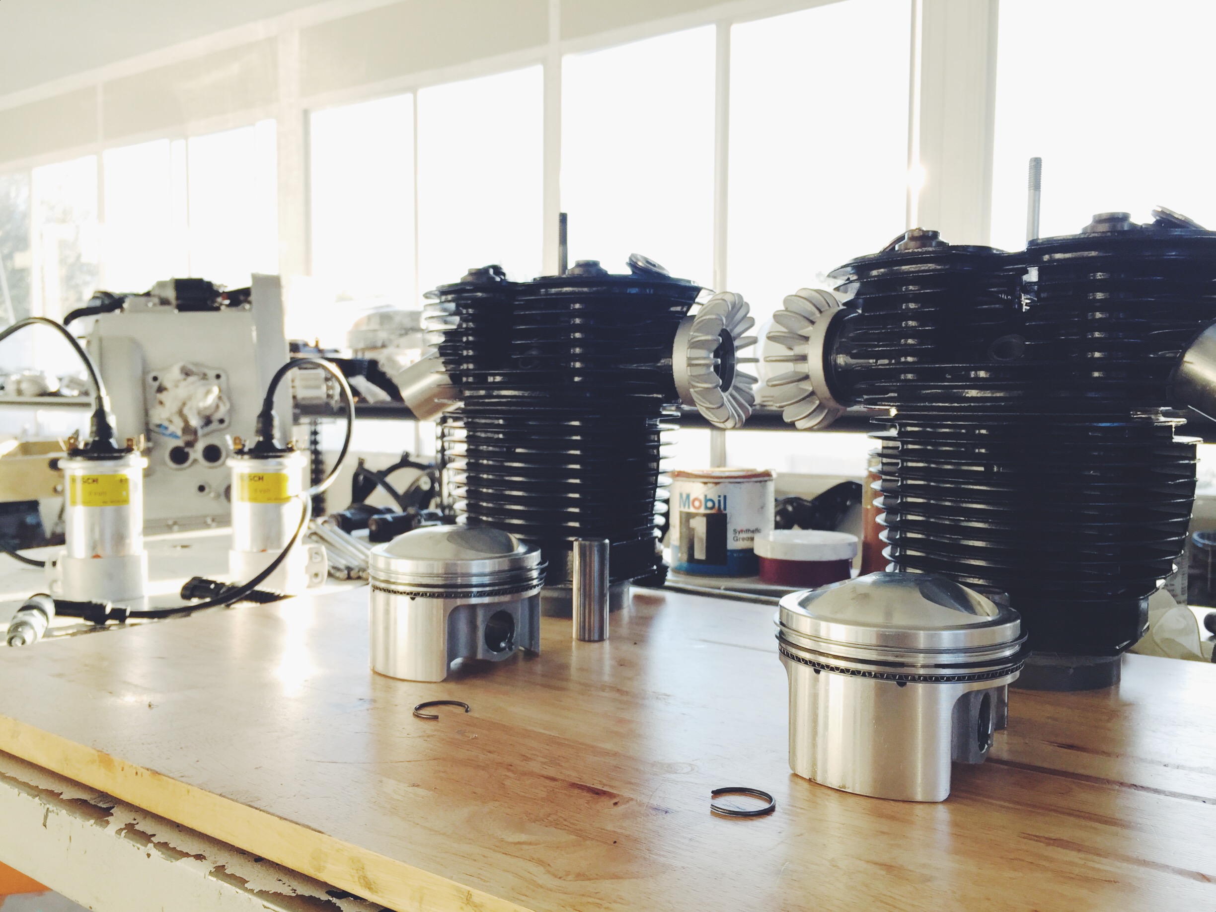 The top-end cylinder jugs and heads are powder-coated. Venturi intake spigots are fitted to the heads for the Dellorto conversion. Custom modern pistons are used.