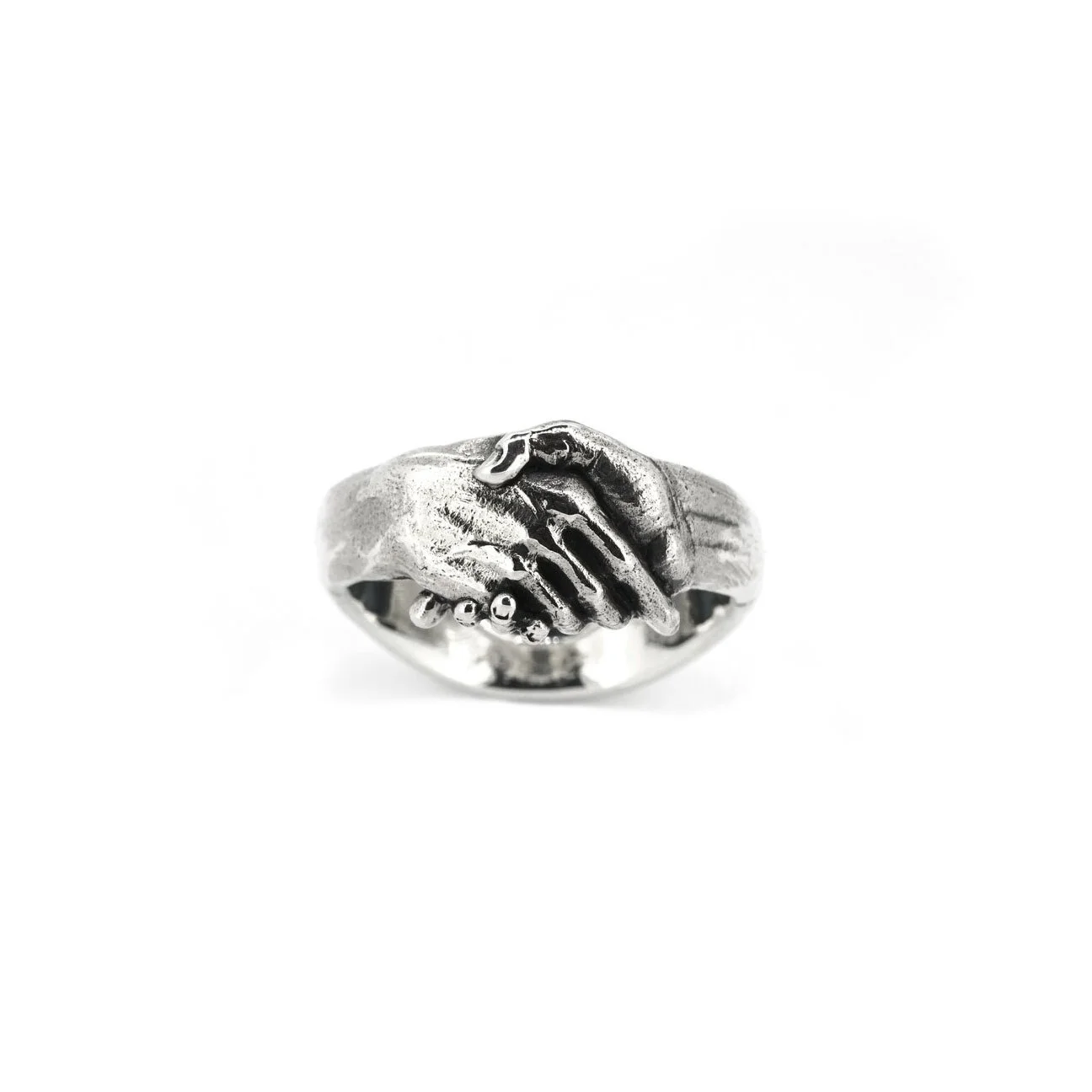Engraved clasped hands ring in silver on white background