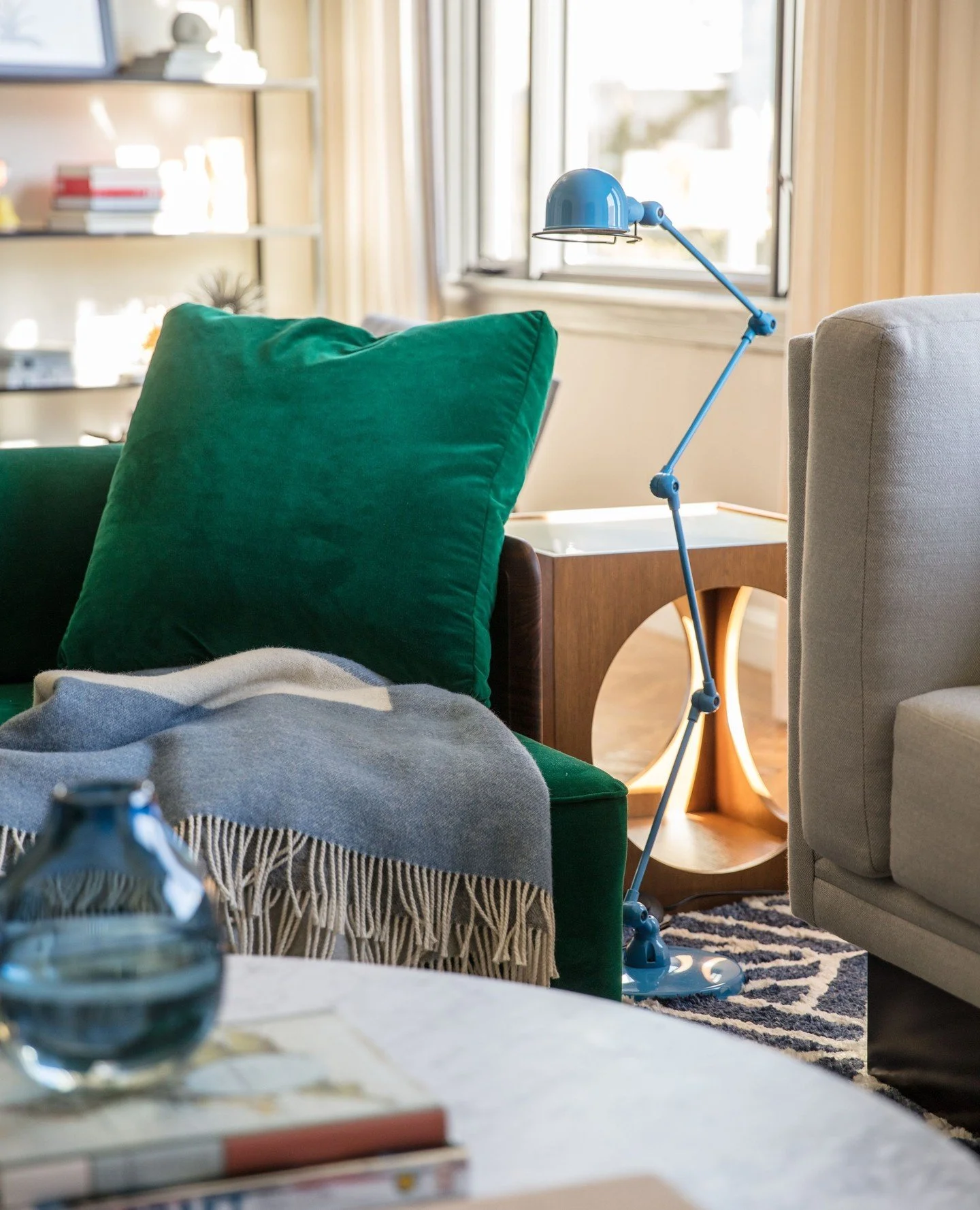 An emerald velvet sofa - paired with charcoal accent paint - create mega mood in this Marina SF Living Room. ⁠
⁠
📸: @kuohphotography⁠ as seen on @elledecor ⁠
⁠
#studiomunroe #roomoftheday #roomwithaview #interiordesign #sanfrancisco