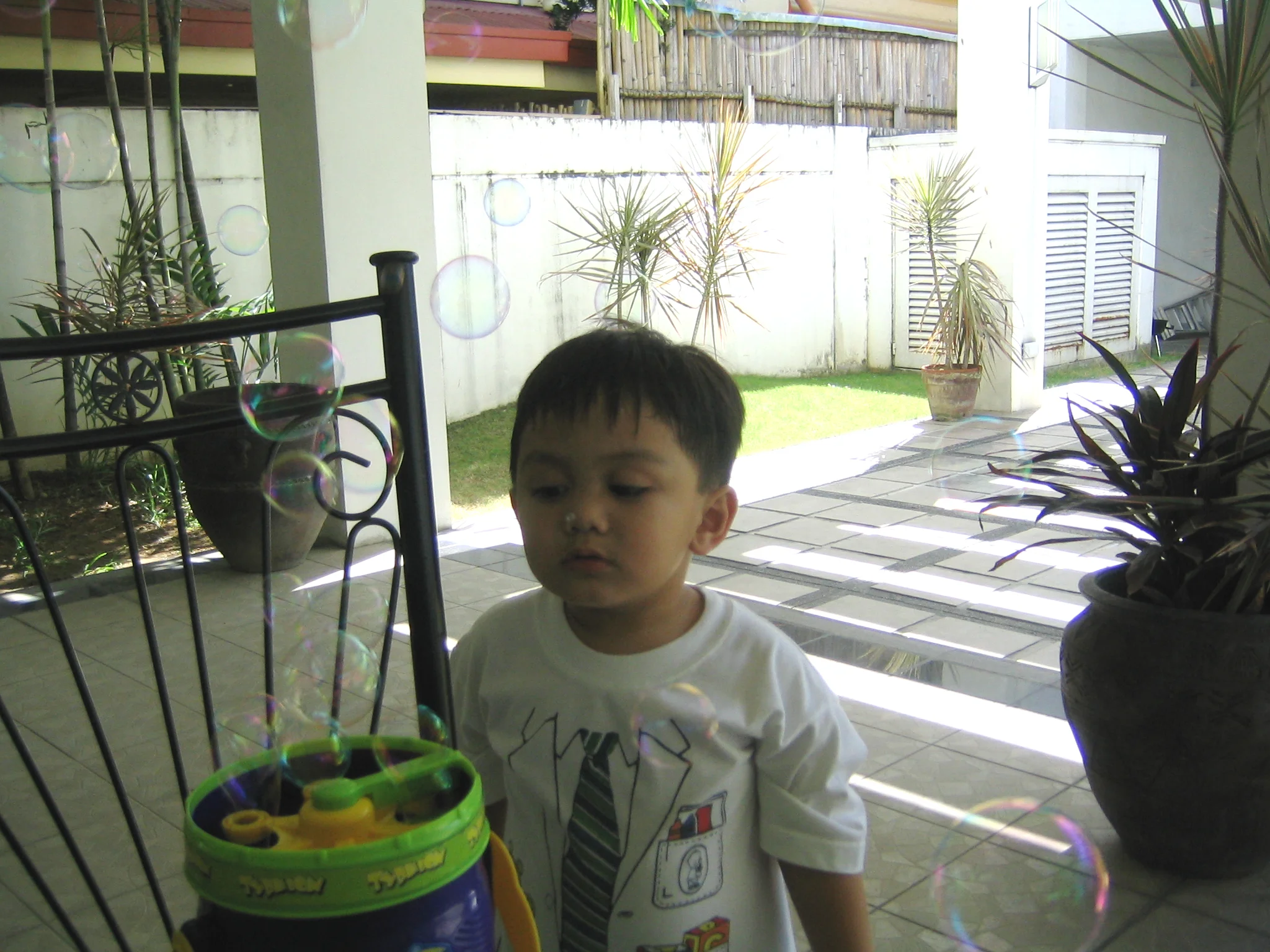 My son studying his brand new bubble machine in lola's (grandma) house.