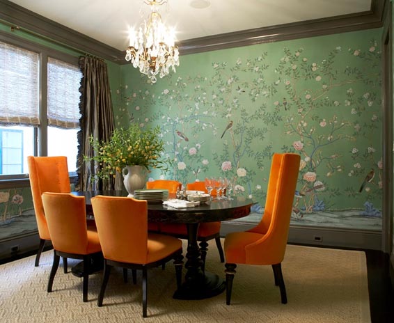 massucco-warner-miller-dining-room-oval-table-crystal-chandelier-bird-green-wallpaper-orange-upholtered-dining-chairs.jpg