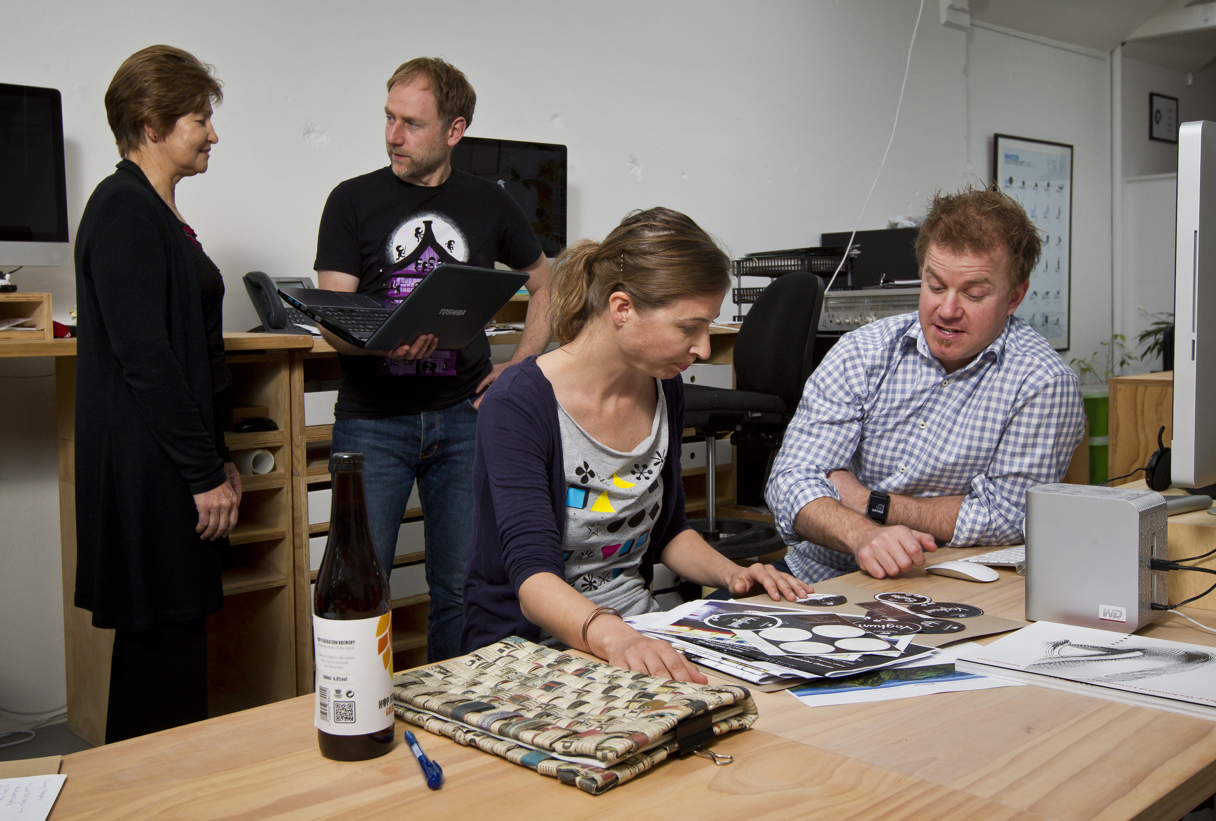 CREATIVE AND CASUAL: CREATIVE AND CASUAL: Members of the Bridge St Collective hard at work – Lynley Lee (consultant at Peritia Consulting Limited and Effectus Limited), left, Edwin McRae (The Fiction Engine), Petra Scheuber (Lucid Design) and Galen King (Collective founder, Lucid Design, Kiwipay). Alden Williams / Fairfax NZ