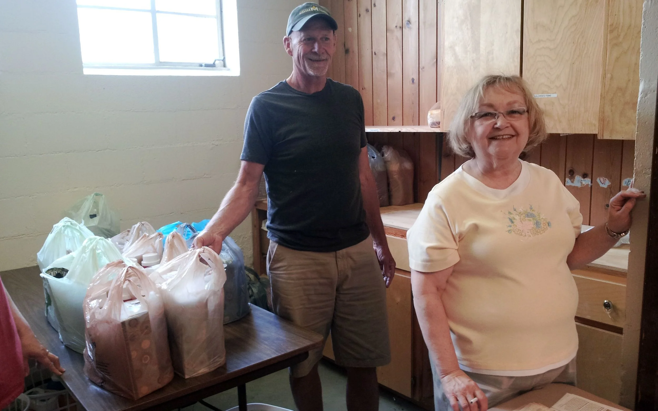 Rick and Chris giving supplies to returnees