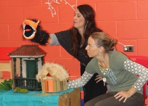 Elisha and Kristin retell their own version of "The Three Little Pigs" contrasting themes of bullying with acts of kindness. This opens dialogue encouraging children to share ideas of how friendship occurs.