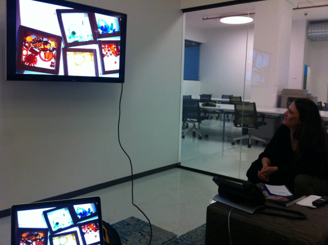 Elisha views the slideshow we are preparing for our presentation at the annual Face to Face conference for arts educators, which will be happening a few days later at City College.