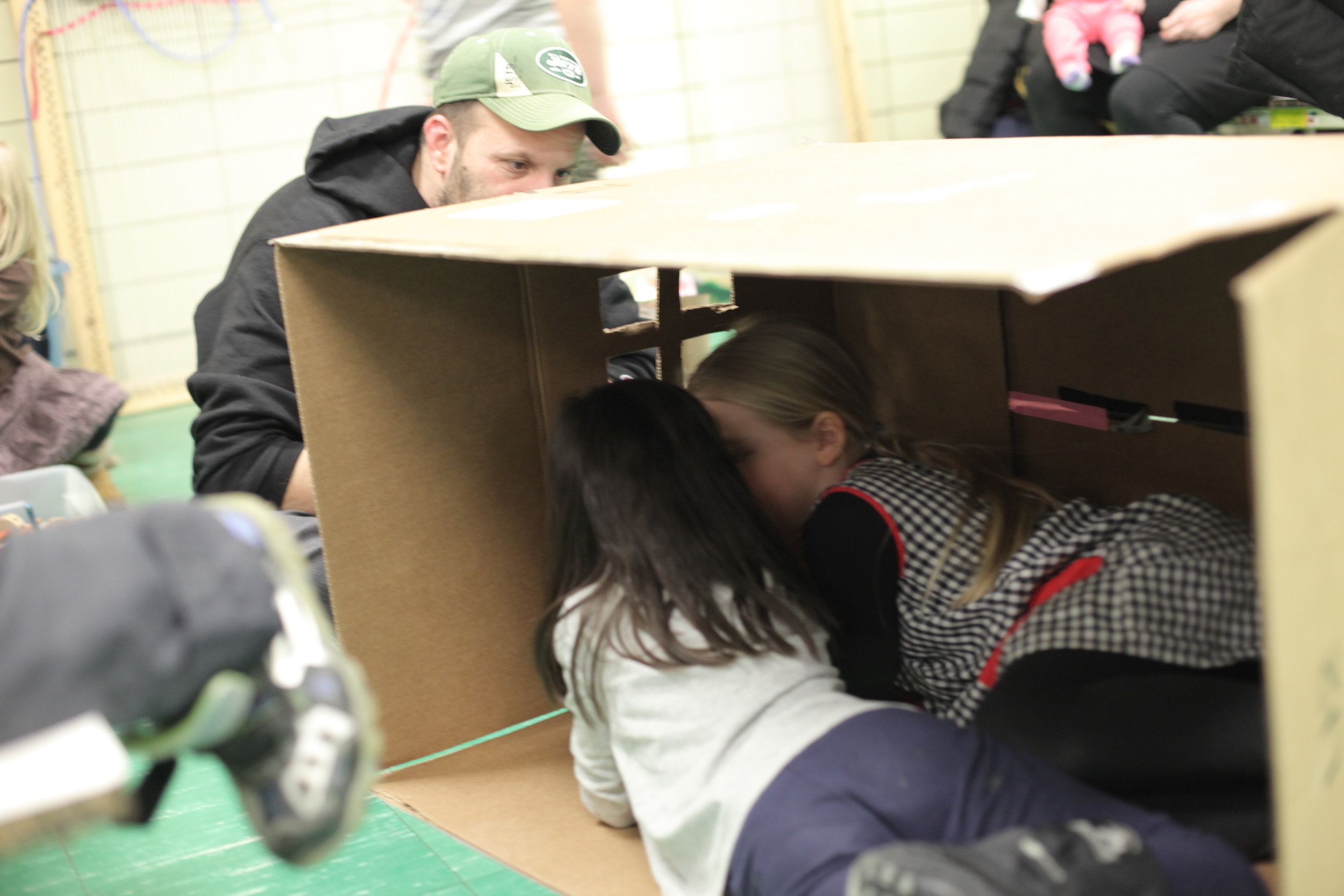 A kind daddy cut windows in our cardboard "house."