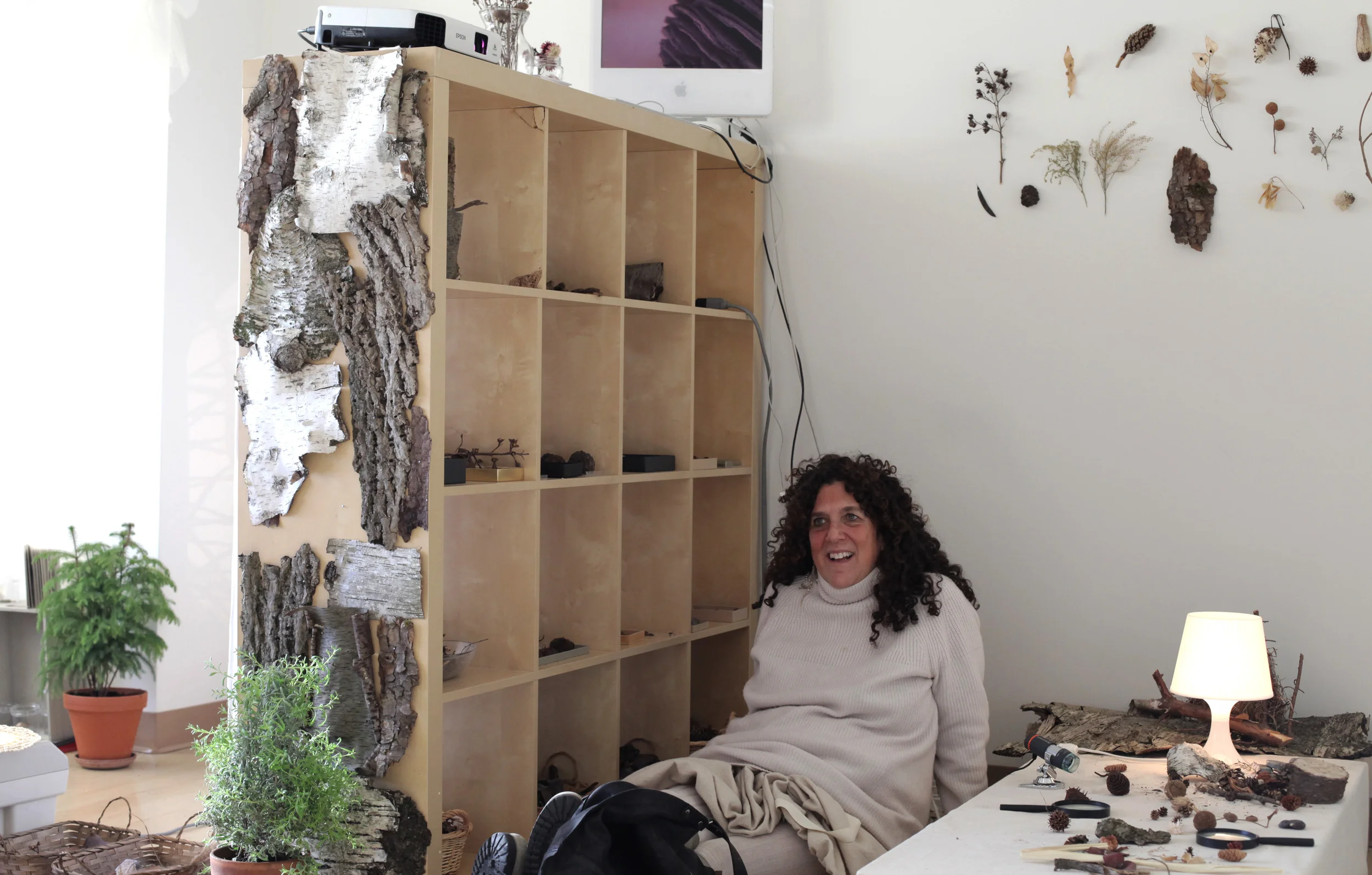 The illustrious Linda White, dressed in white, engaging with visitors in a beautiful white room called the Natural Materials Atelier. Here is the room in its first mood, "Forest." It went on to become transformed, thanks to the work of Robin Koo, into "Ocean" and "Plants." Linda was one of the many NYC-based educators who volunteered to set up and maintain the ateliers and show visitors around. 