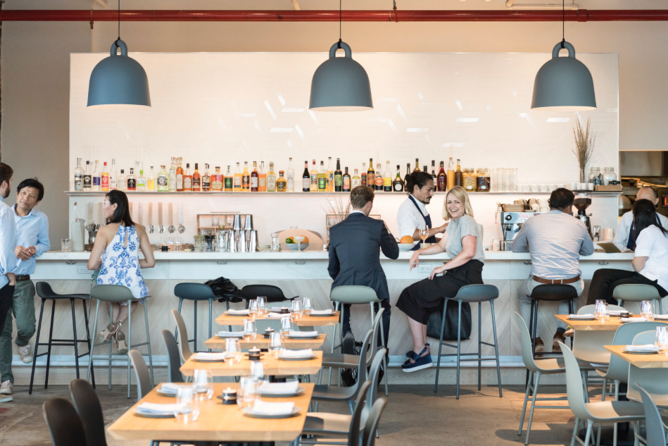 EXAMPLE OF A RESTAURANT WITH CONCRETE FLOORS AND HIGH CEILINGS.