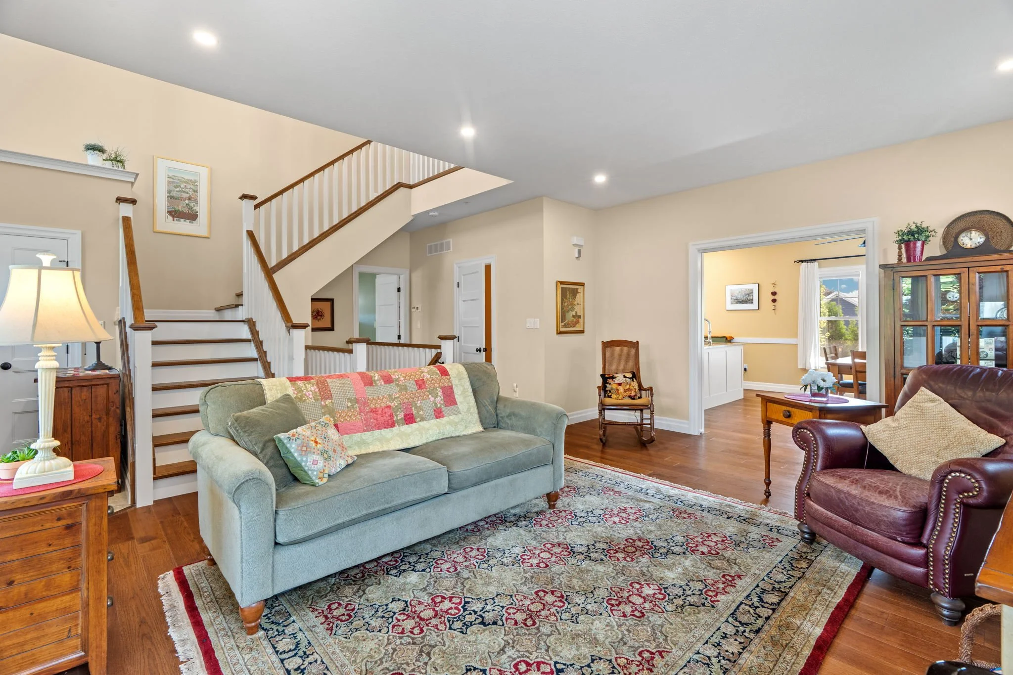Generous sized Living Room with Gas Stove. Note custom staircase.
