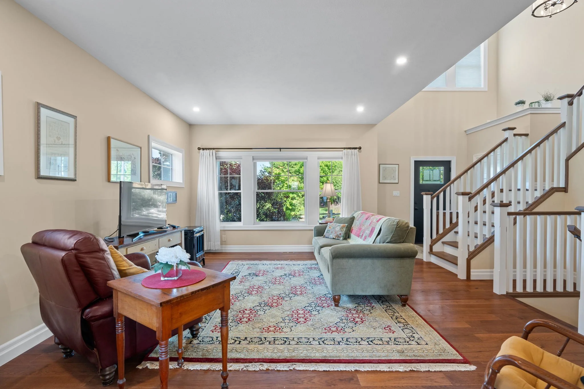 Living room has views to a treed parkette across the street.