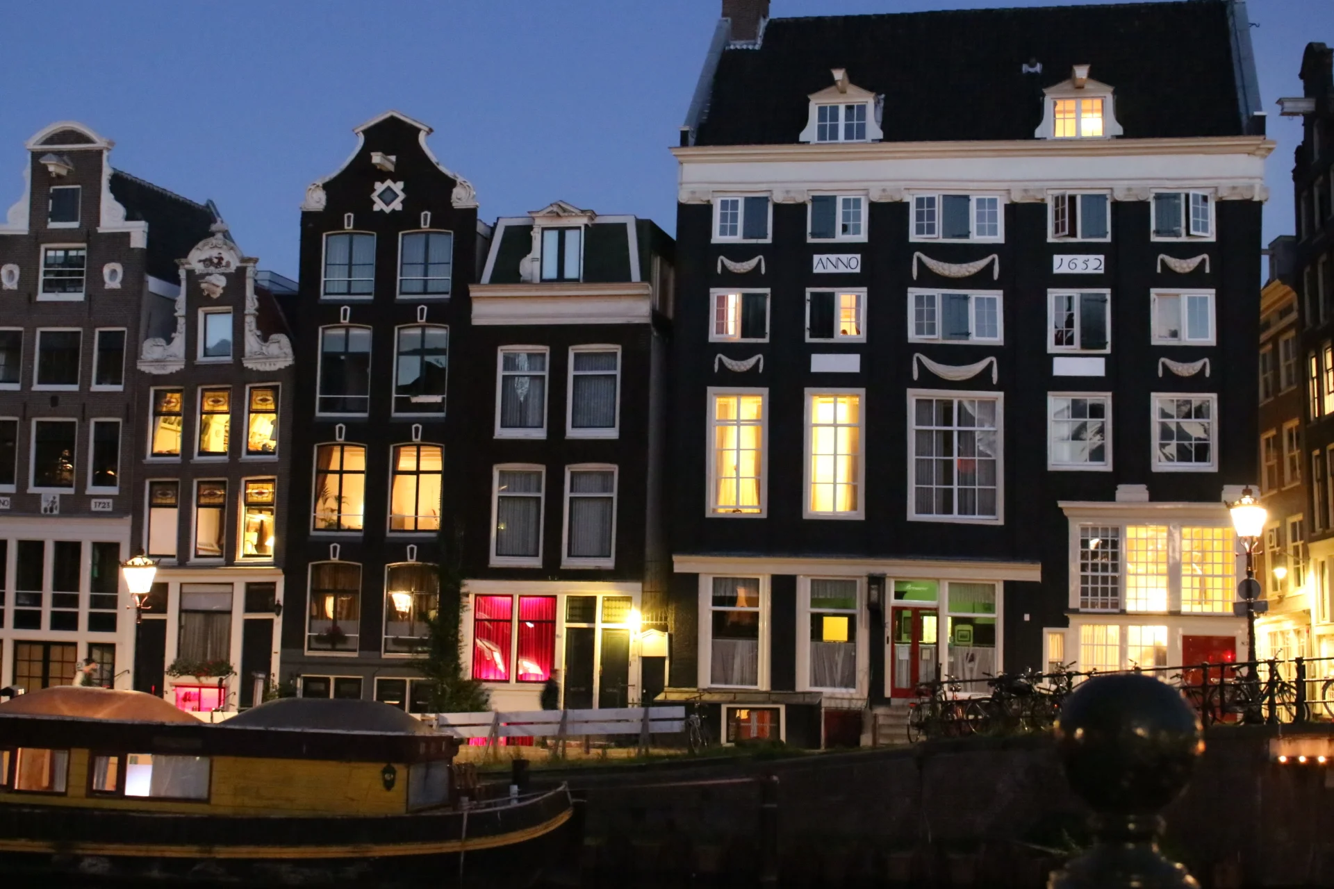  Red light windows can be seen among charming buildings all over Amsterdam.&nbsp; 
