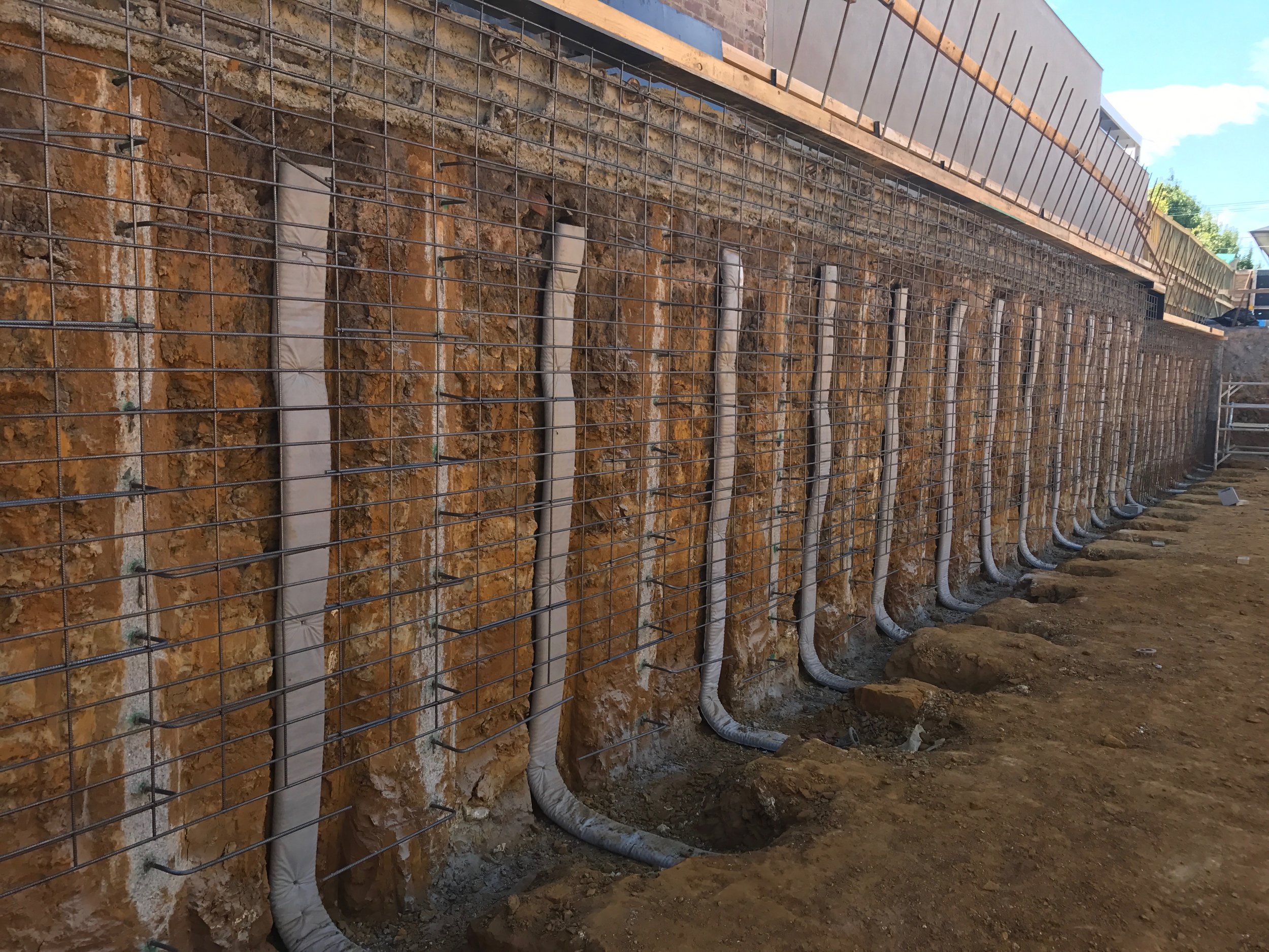 Here we have placed strip drain in between the concrete piling, this will create the necessary void and drainage behind the shotcrete walls.