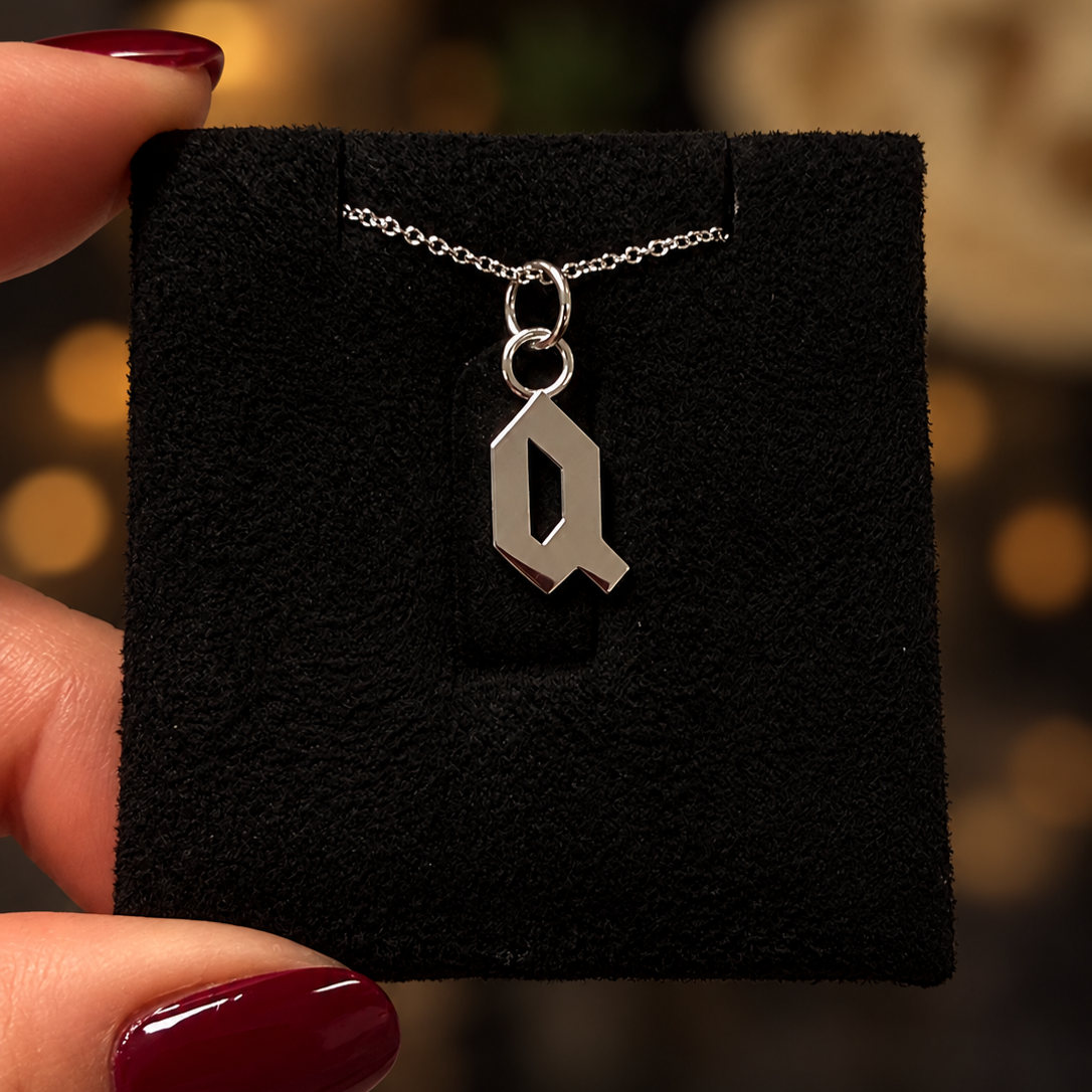 Silver+Q+Pendant+on+Velvet+Display.png