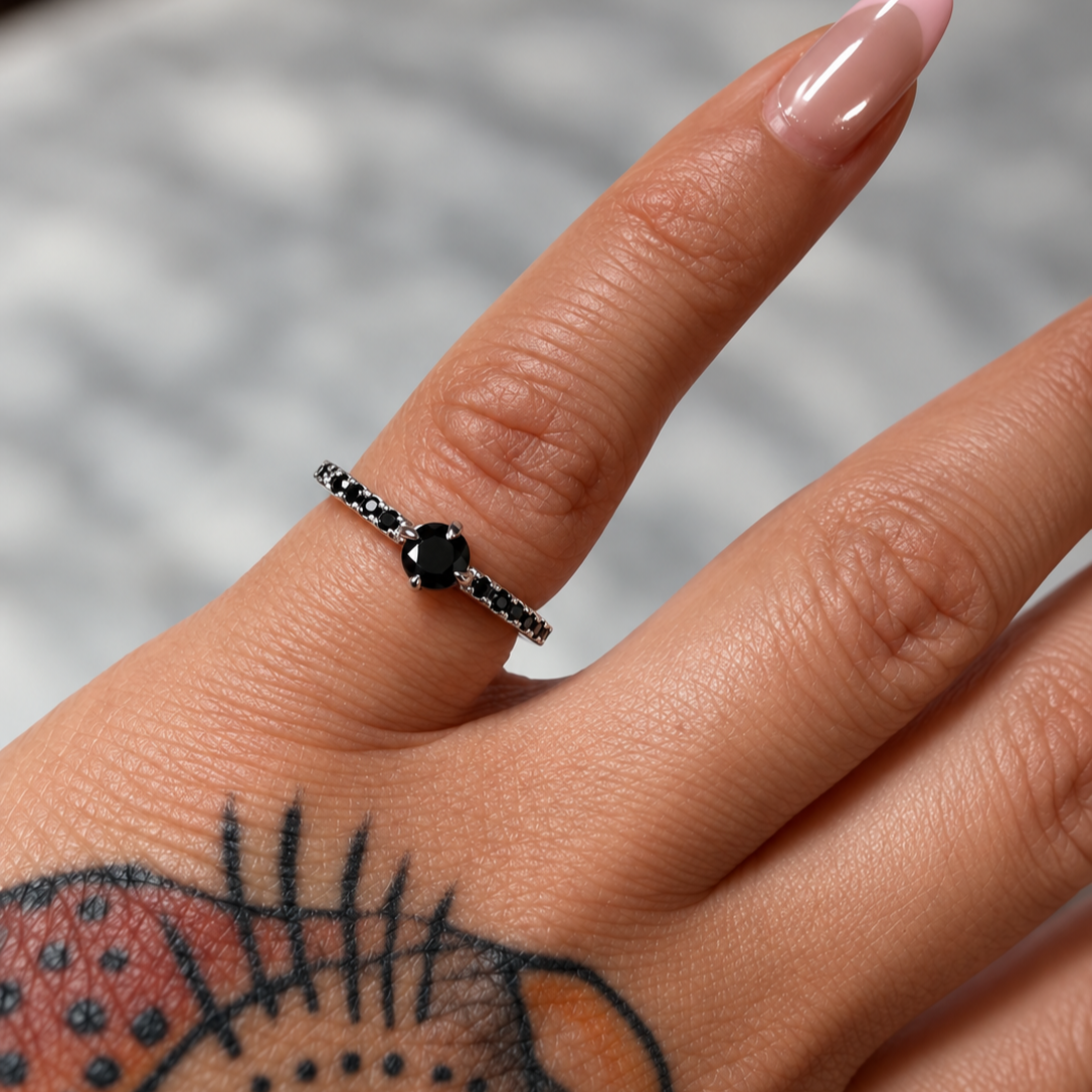 Black+Gemstone+Ring+and+Manicured+Hand.png