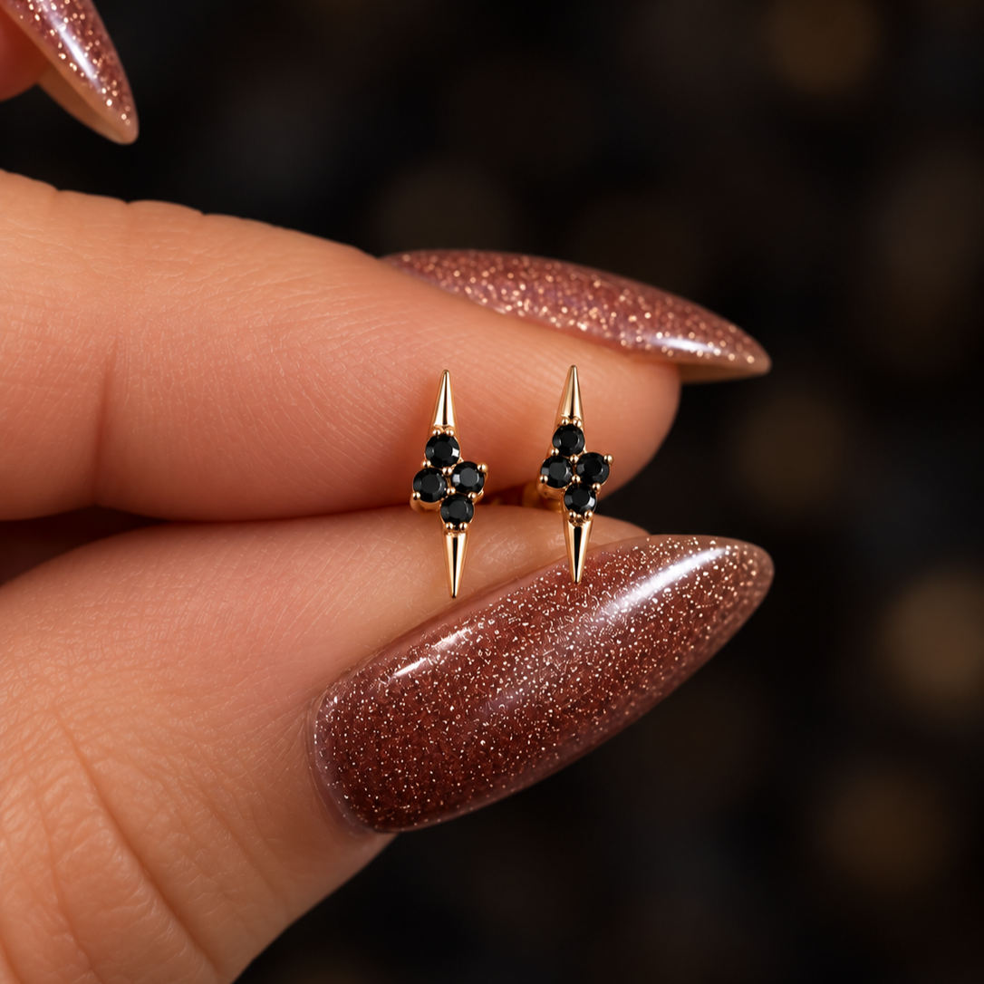 Gold+Spike+Earrings+on+Glittered+Fingertips.png