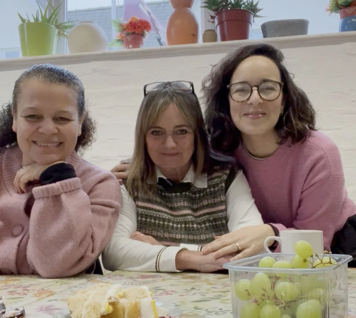 three women smile at the camera