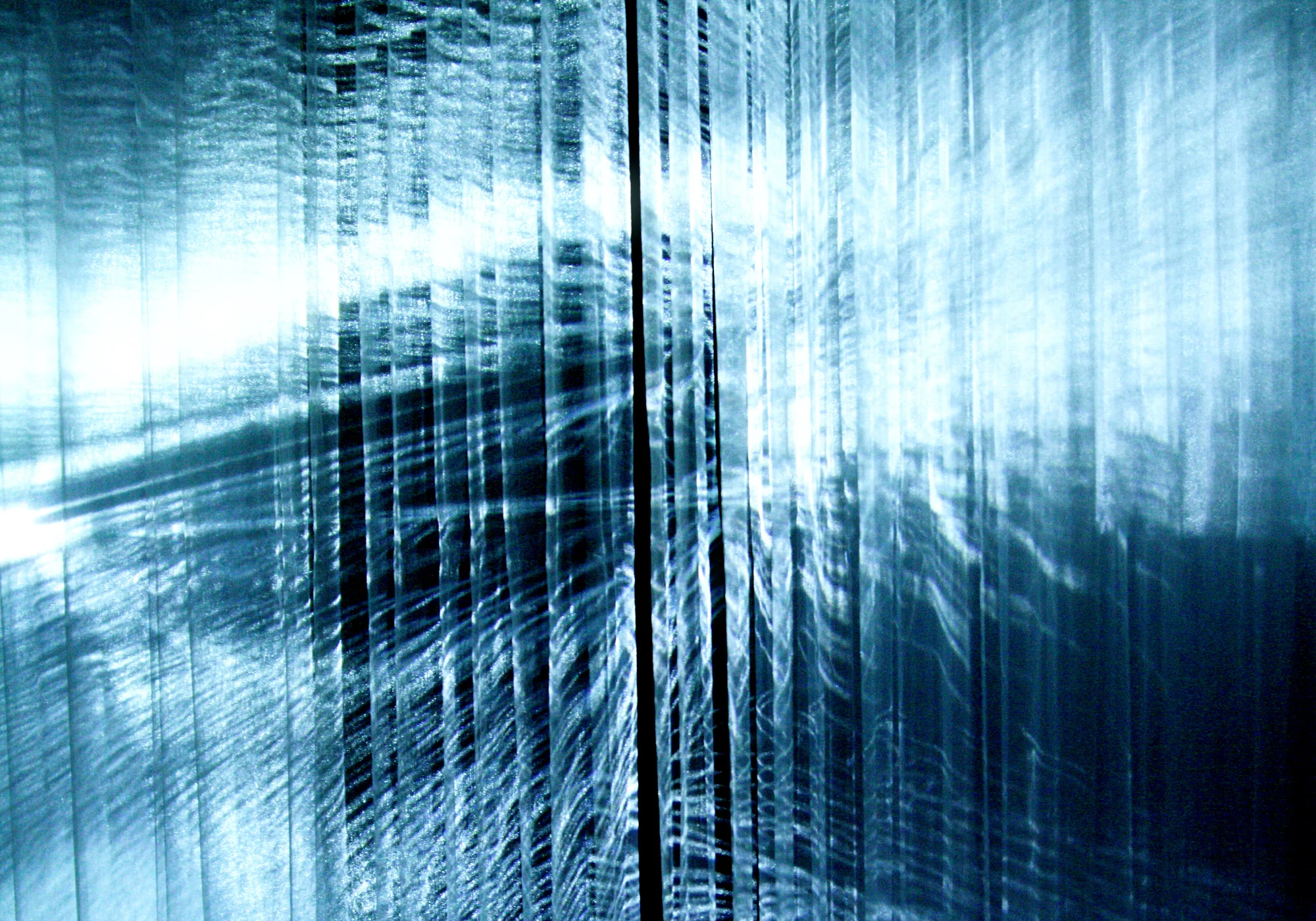 Depth is created by projecting images onto the layered fabric of the projection surface.