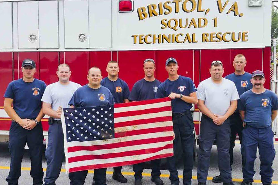  Nine members of Bristol’s Swift Water Rescue team that saved 44 people from floodwaters in Rainelle on Friday morning are photographed with a U.S. flag they saved from the heavily damaged West Virginia town. The fire department plans to frame the fl