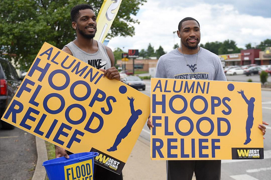  Former WVU basketball players John Flowers (left) and Kevin Jones collect donations for flood victims, Wednesday at the intersection of Patterson and University ( via ) 