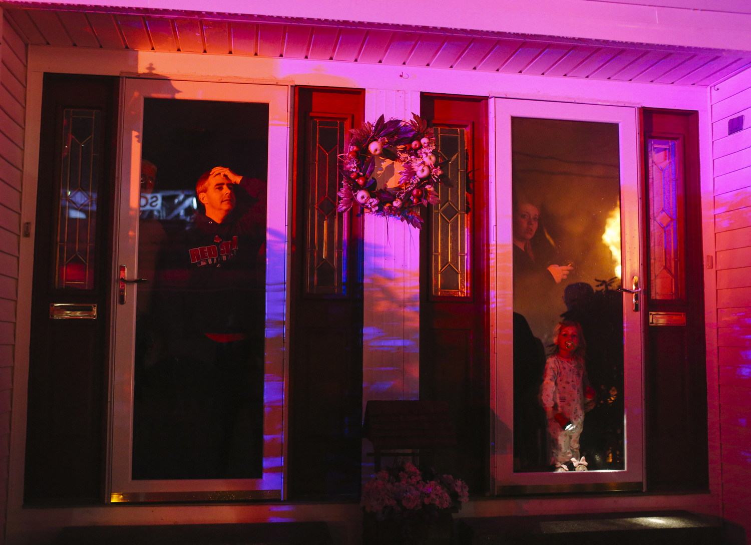 Neighbors watch as the building across Greene Street burns while firefighters try to put out the flames in Biddeford, ME on Sunday, November 23, 2014