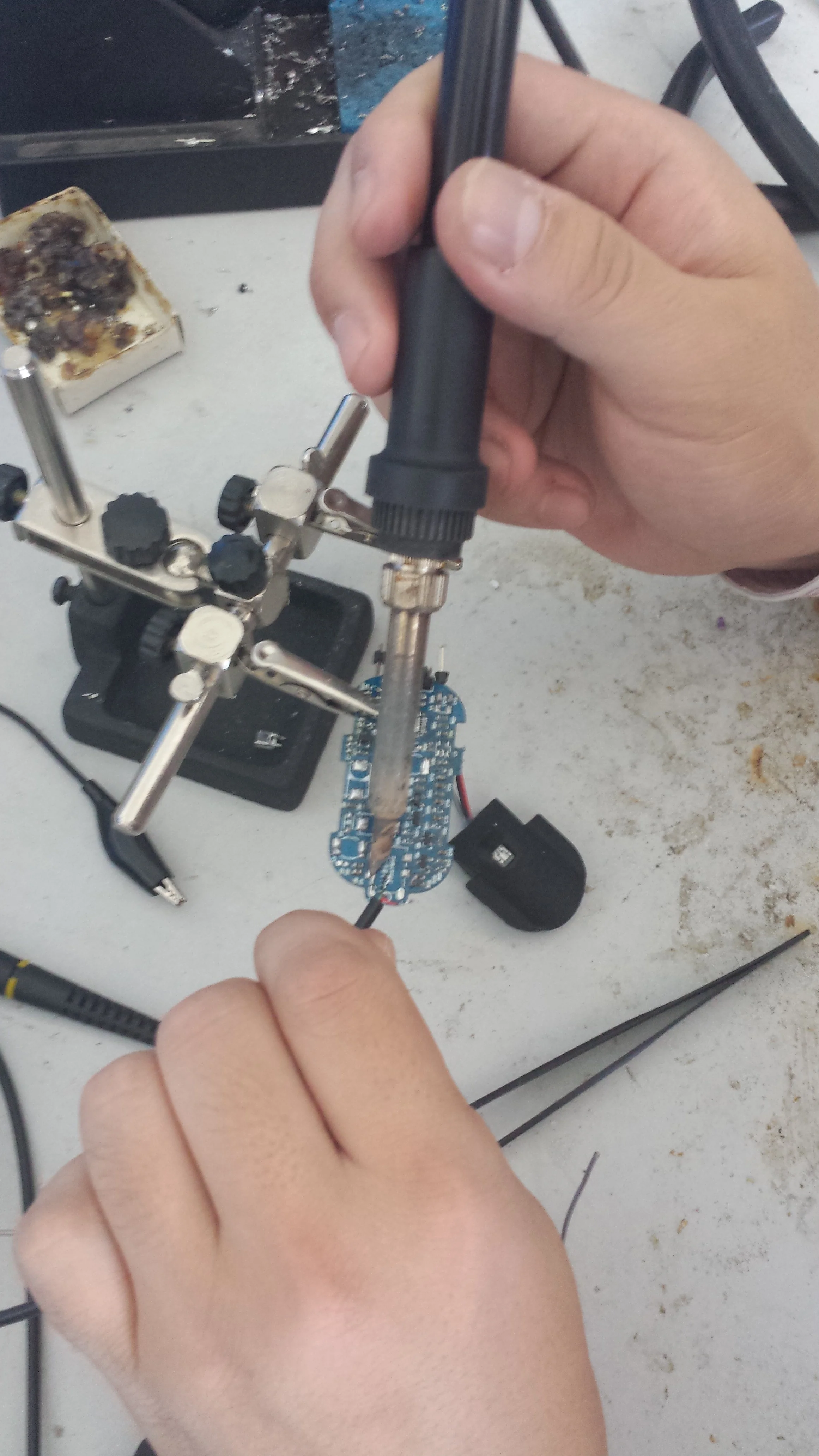 Hand-soldering the new board.