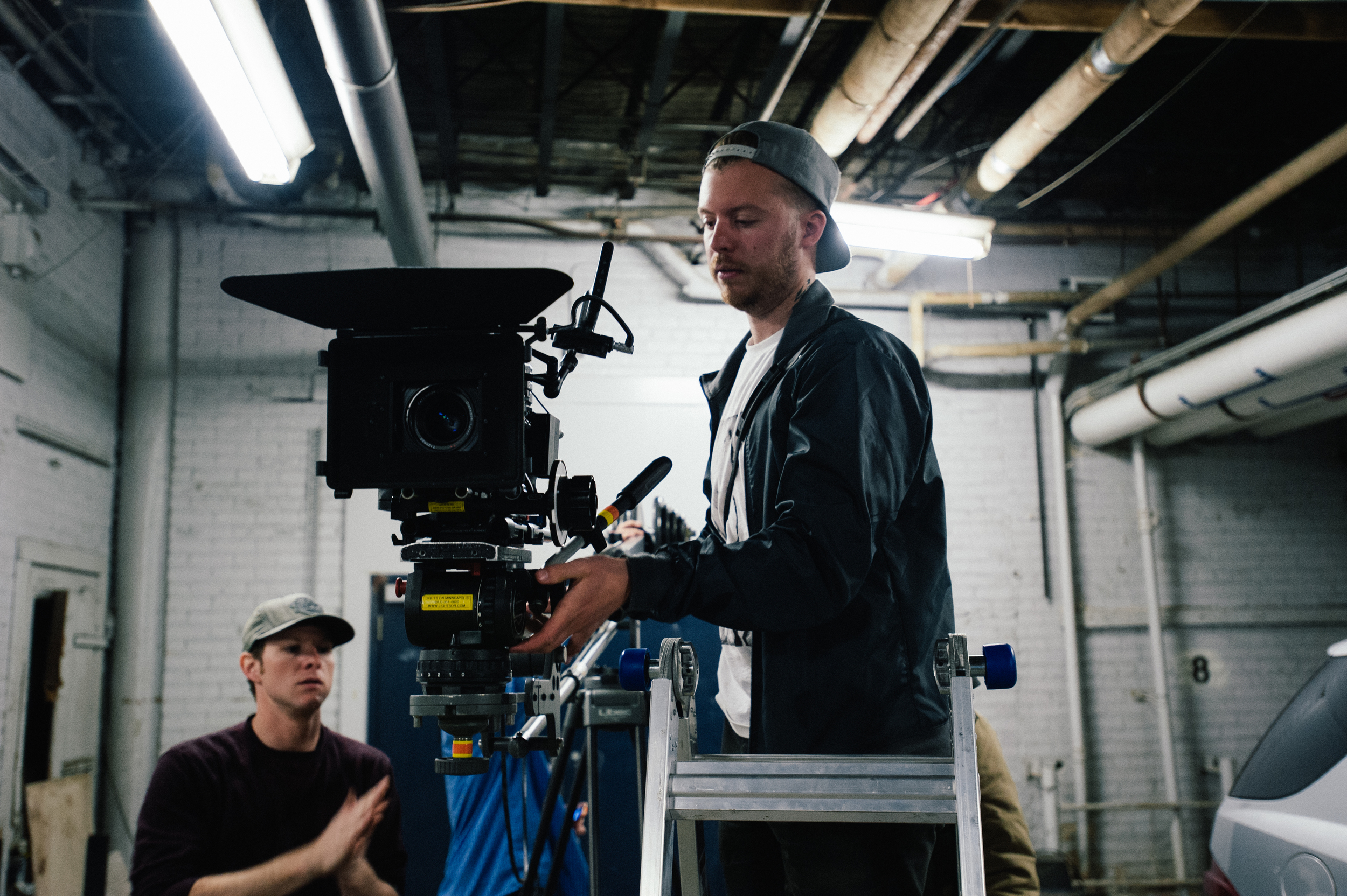 CInematographer Kevin Horn uses a ladder to get his camera into position