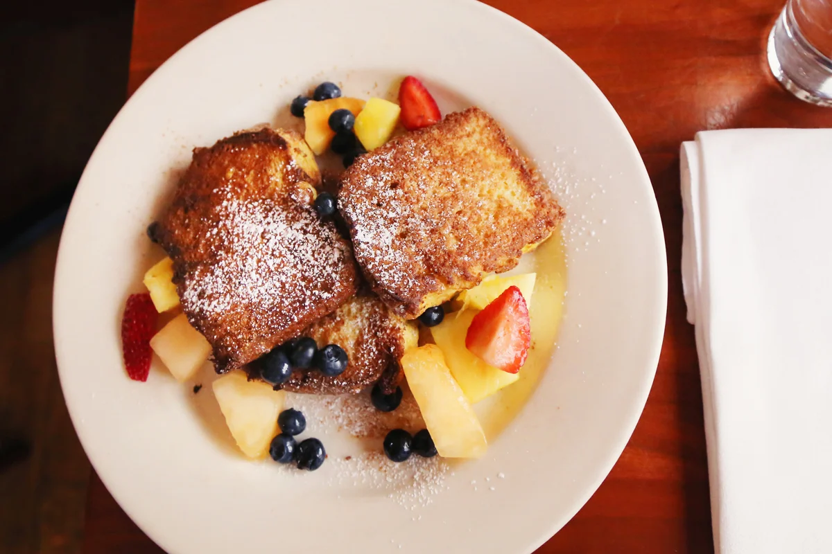 French French Toast (Fried in Bourbon Egg Batter, served with Maple Syrup and topped with fresh fruit.)