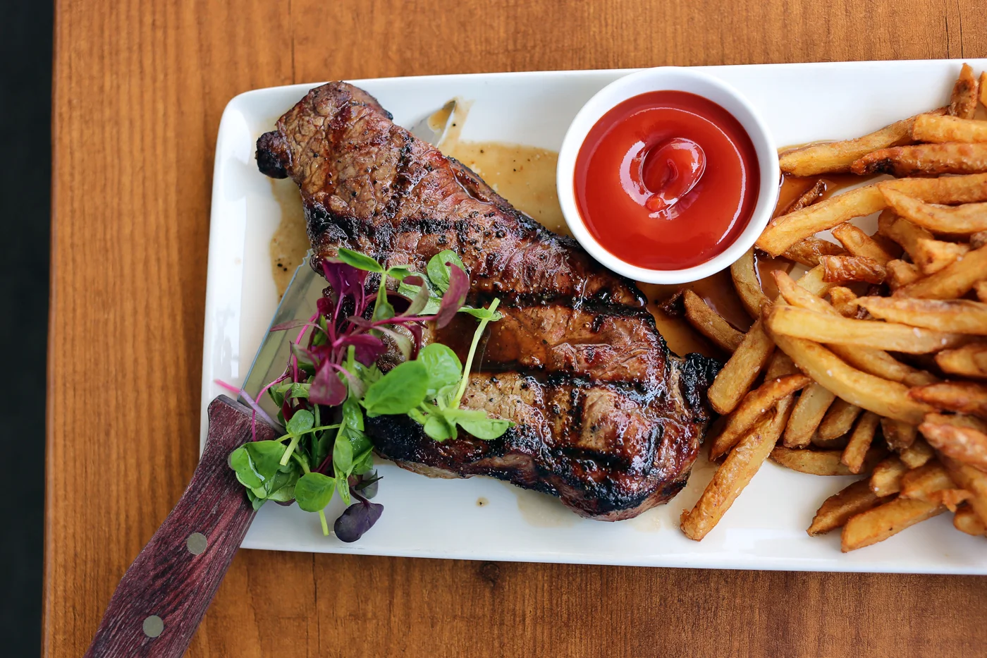 Tavern Steak - Grilled 8oz striploin steak topped with demi-glace, served with fresh hand cut Yukon Gold fries