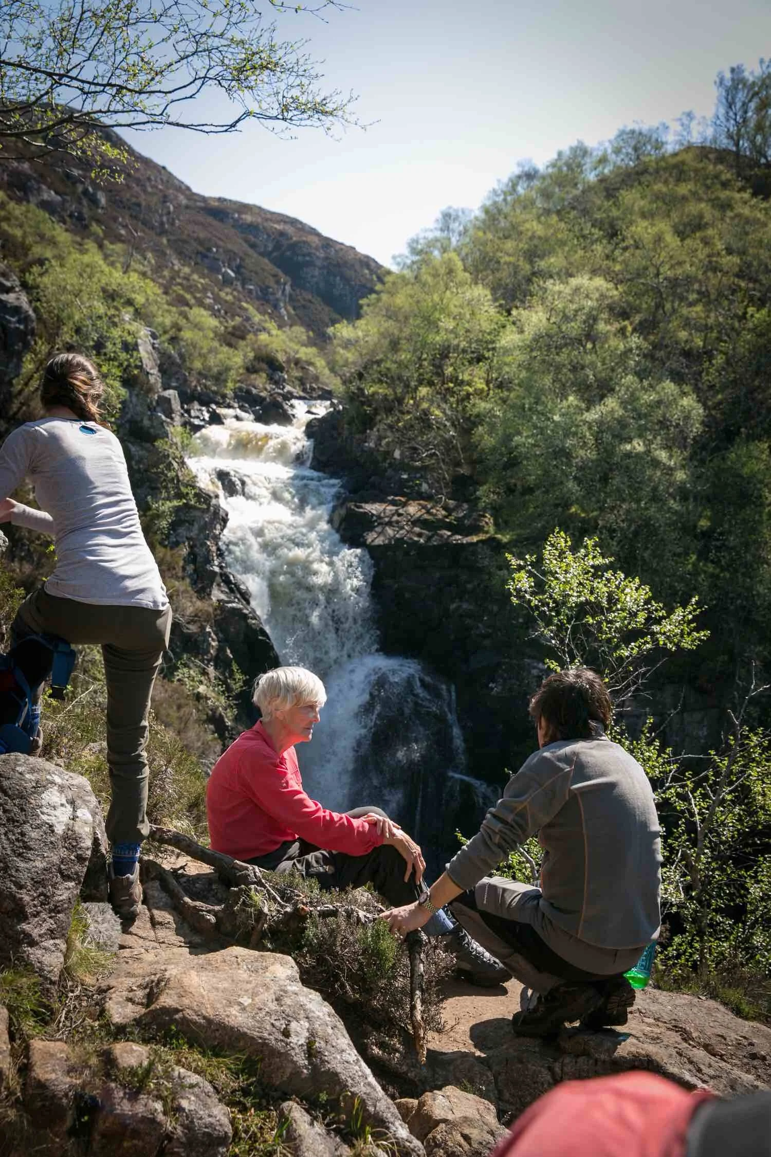 Edie pauses for lunch next to a waterfall. Simon and Sheila Hancock discuss.