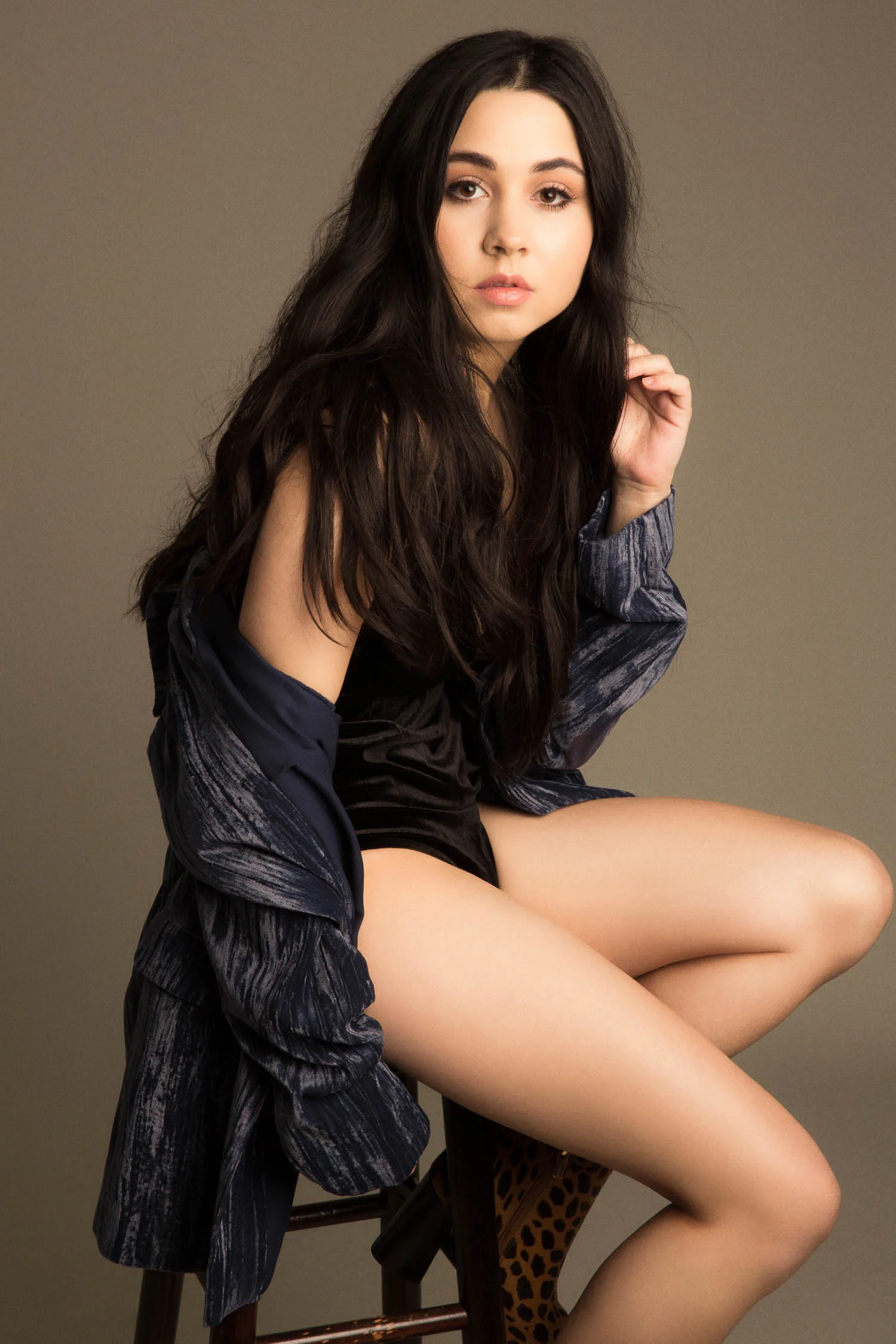 model sitting on a stool