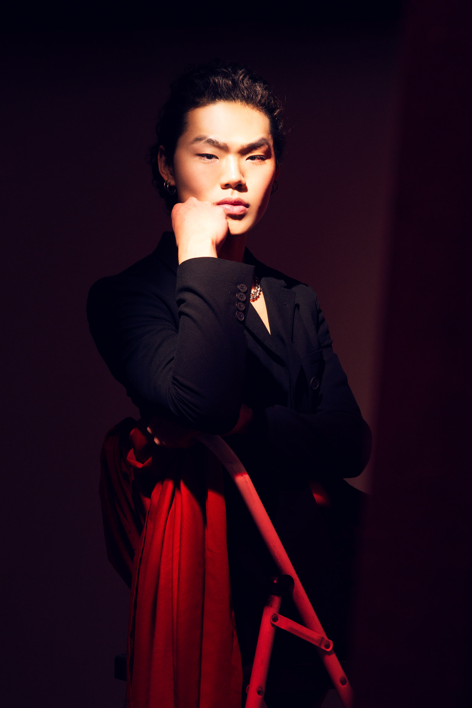 Portrait of a male model in a red room.