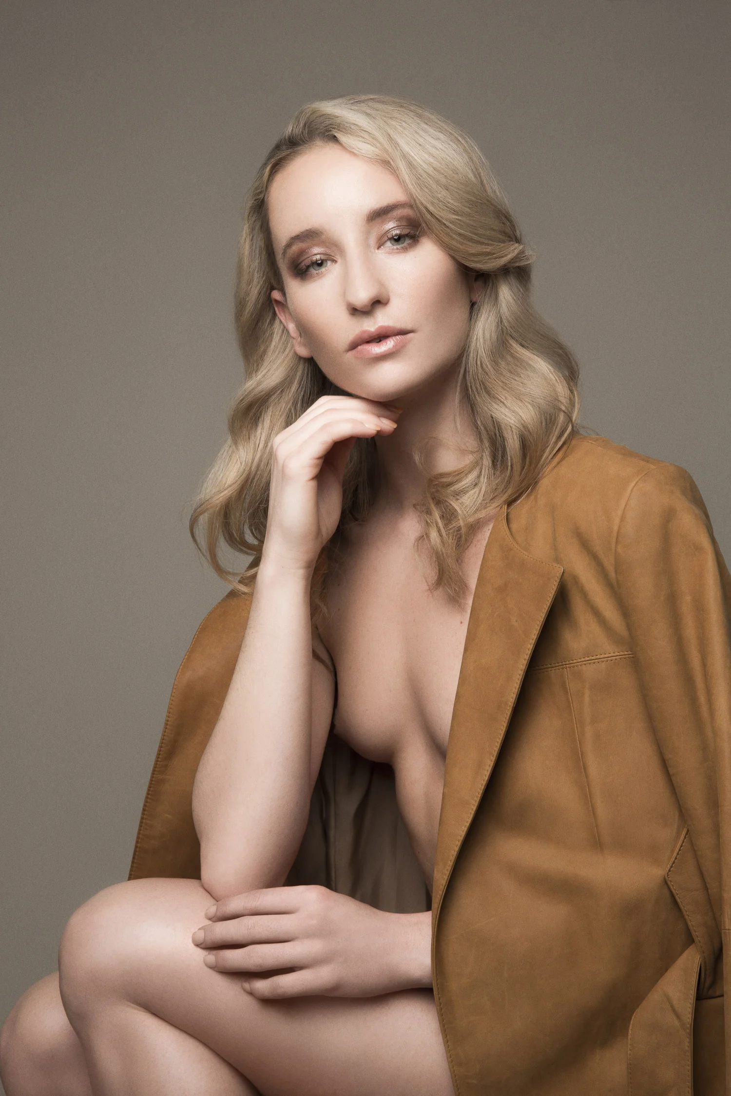 Blond model in leather trench coat