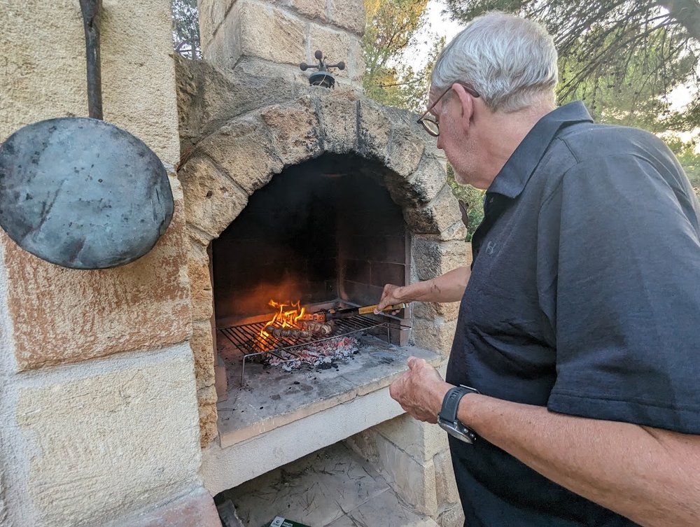 Dave grills Apulian bombettes on our outdoor oven