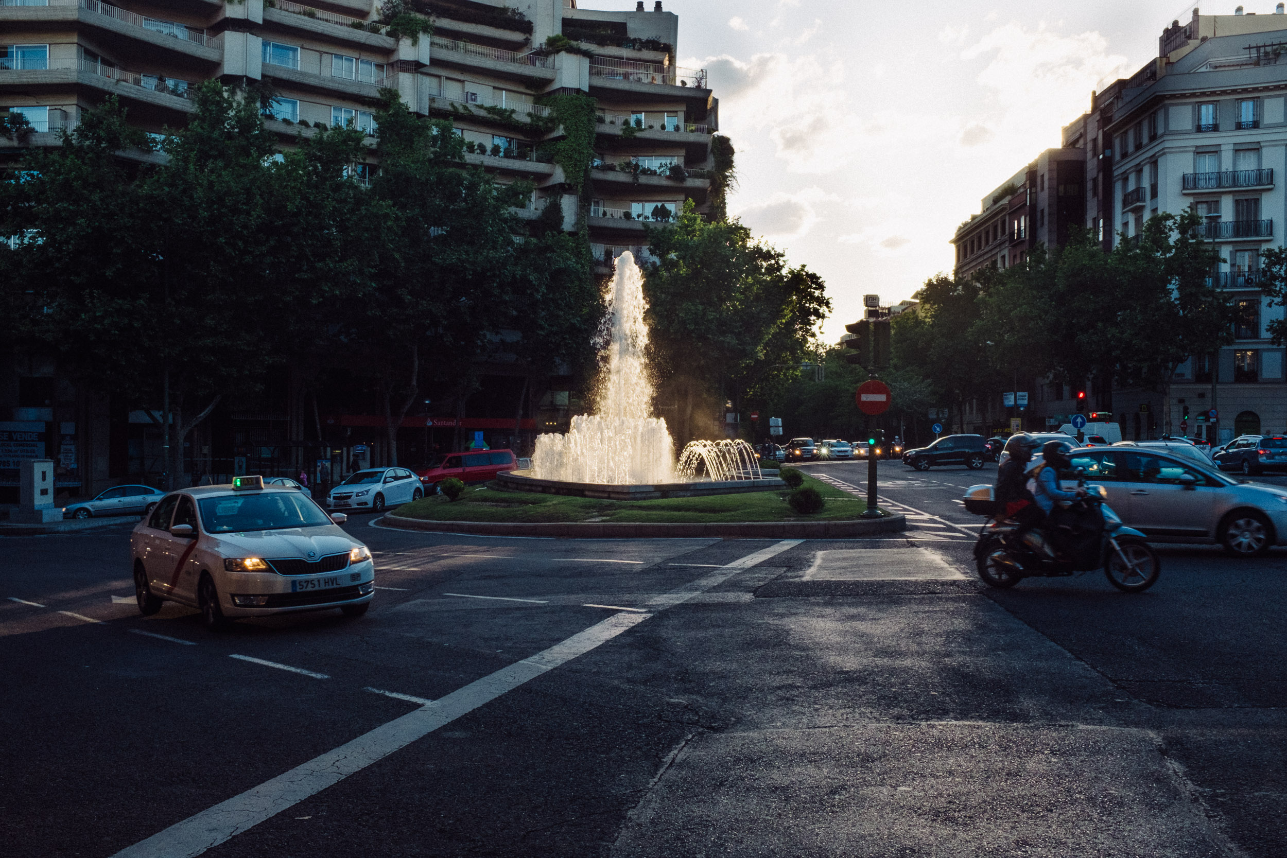 Cars passing fountain in a roundaboutin Madrid, Spain