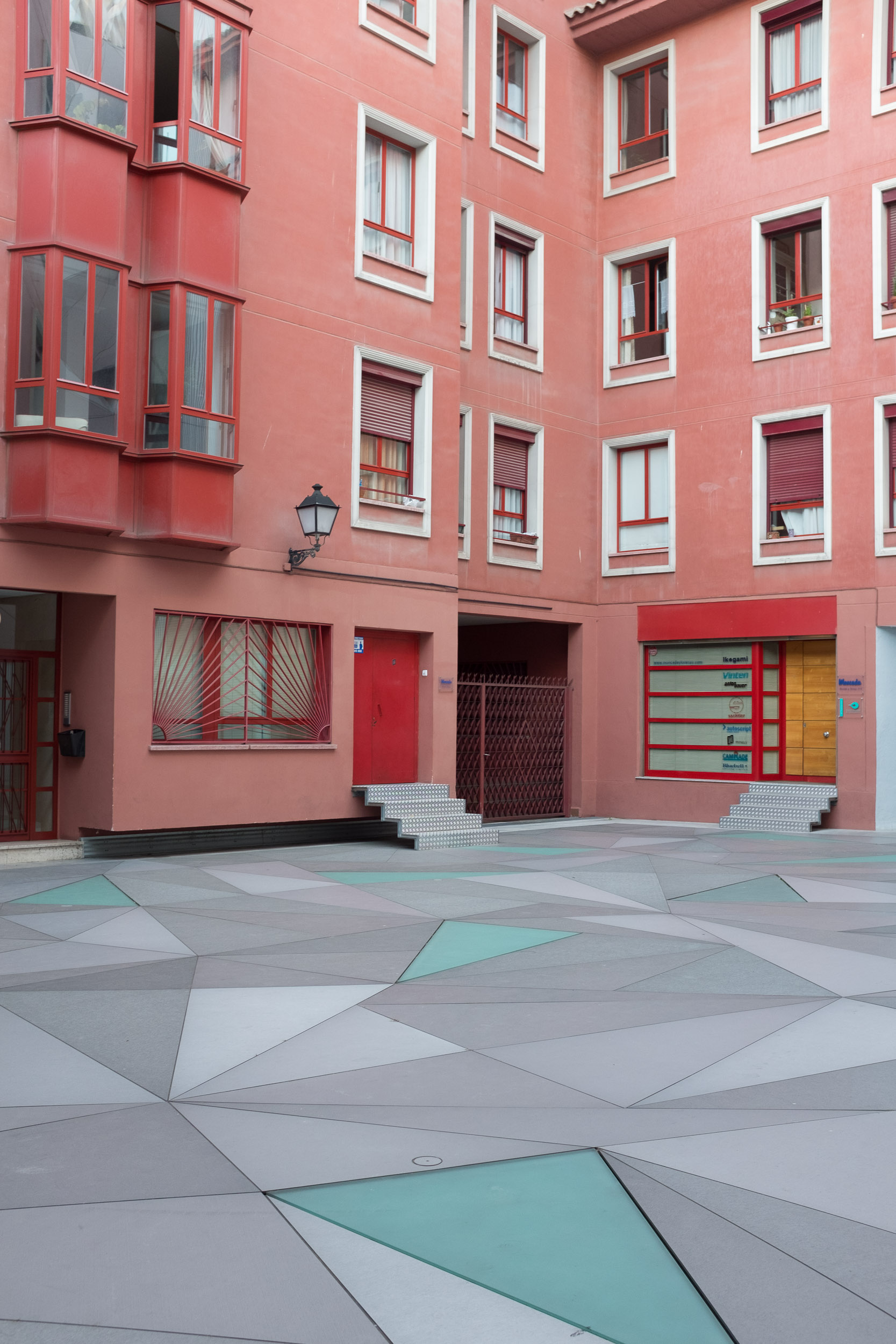 Pink builing with geometric courtyard in Madrid, Spain