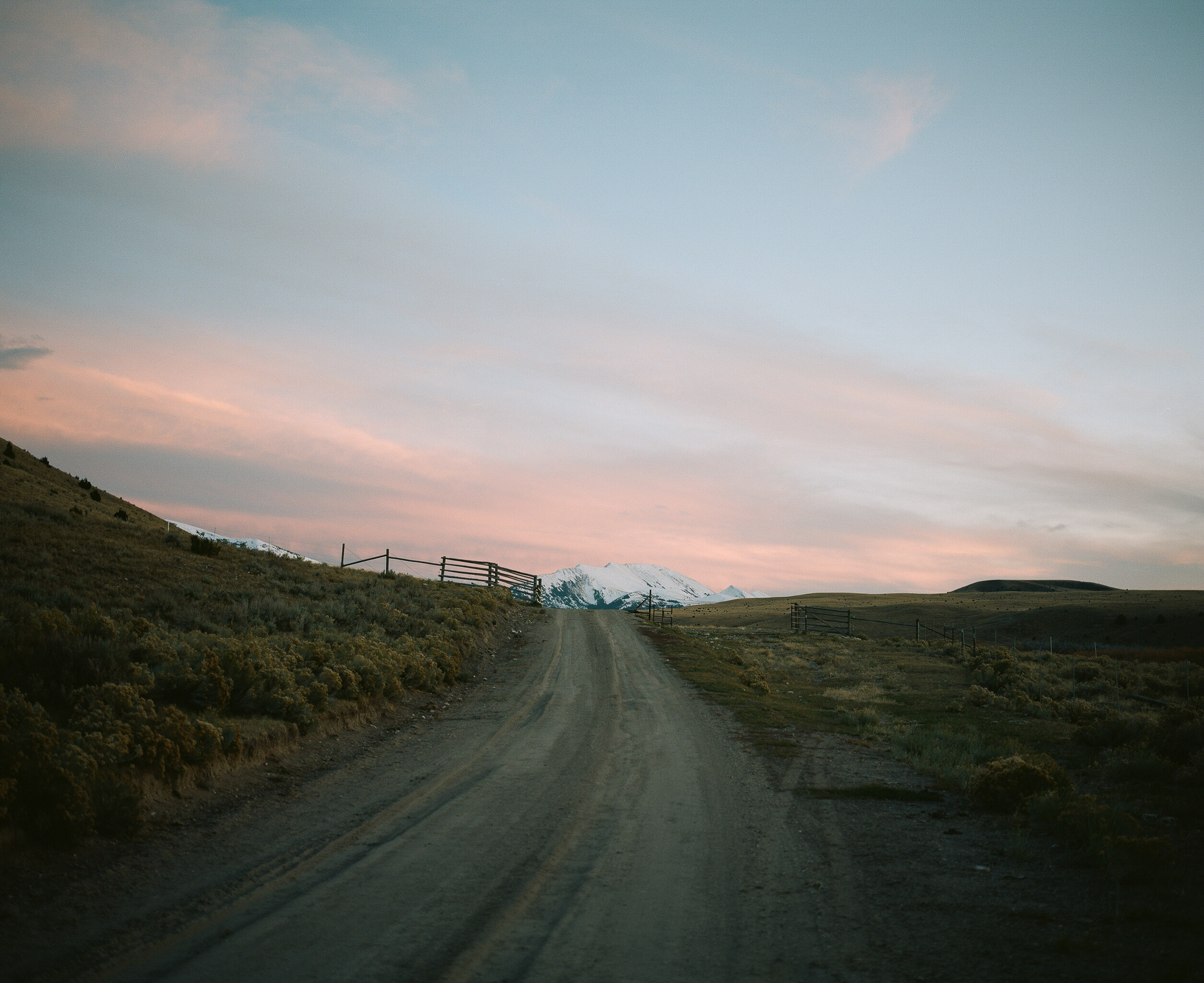 Backcountry Road  in front of a snowy mountain at Sunset, 