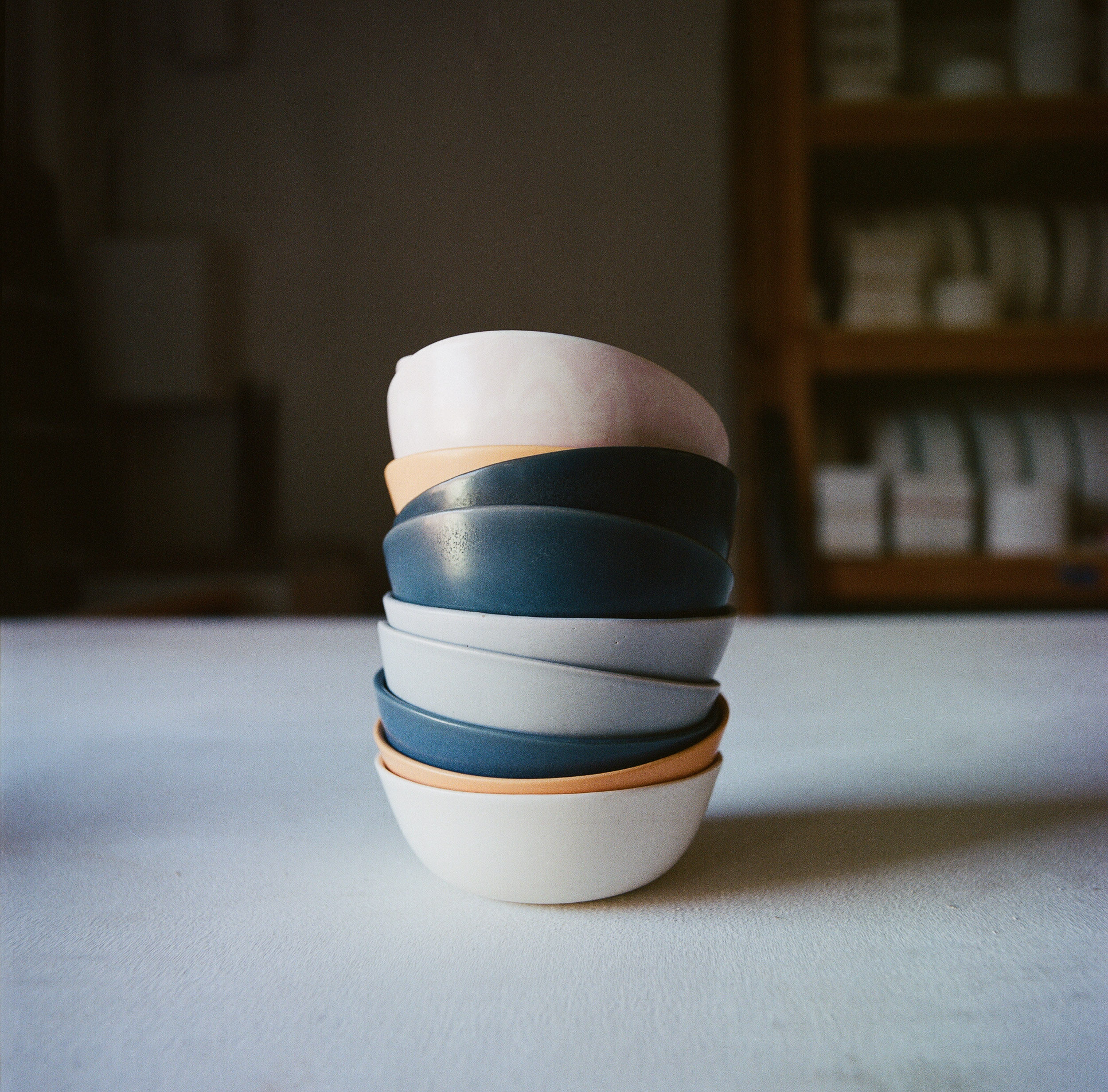 Stack of multi-colored ceramic bowls by Felt+Fat