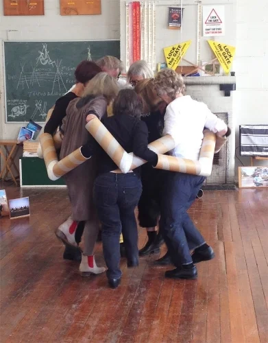 Instruments of Democracy , 2015 Performance objects - metal, cardboard, mixed media 10 performances in Kandos Scout Hall, 9-12 April 2015, for Cementa15 contemporary arts biennial This short, empathetic performance by WRVAP artists was inspired by the courage, ingenuity, discipline and stamina of environmental activists from all walks of life 'locking-on' against new coal and CSG. The piece, acknowledging the role of witnessing in non-violent direct action, was accompanied by an installation of 40 activist portraits along with individual works by WRVAP artists.