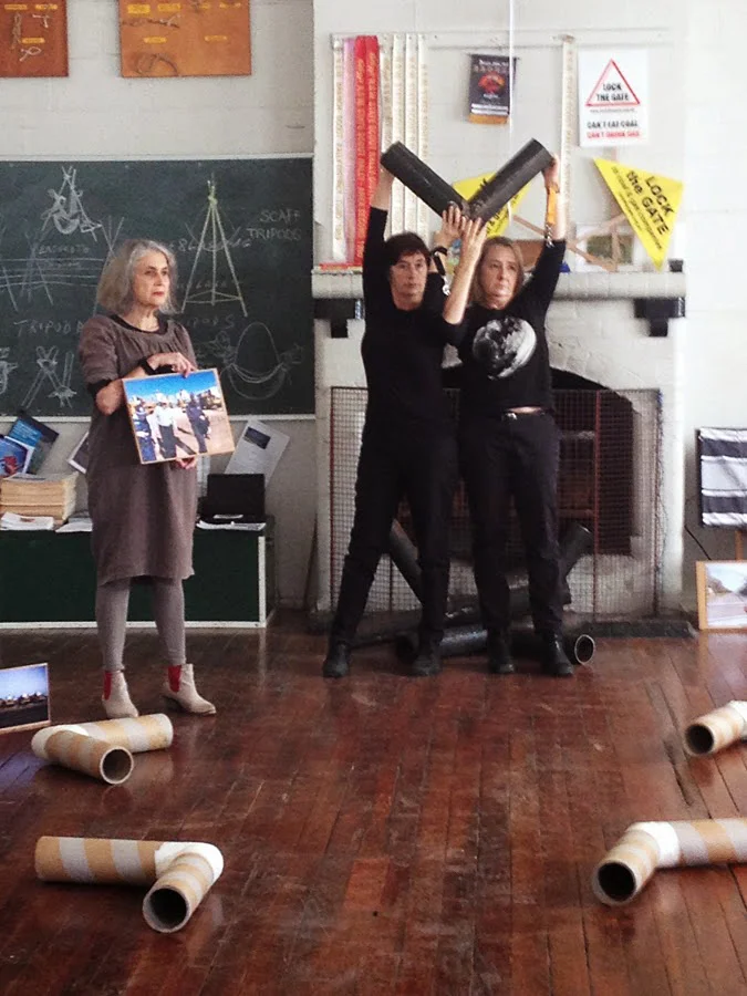 WRVAP artists (l. to r.) Toni Warburton, Suzanne Bartos and Juliet Fowler-Smith mid-performance… Toni ‘witnessing’ the arrest of 93-year-old Bill Ryan (whose ‘activist portrait’ she holds) protesting Whitehaven’s Werris Creek coal mine in 2014.