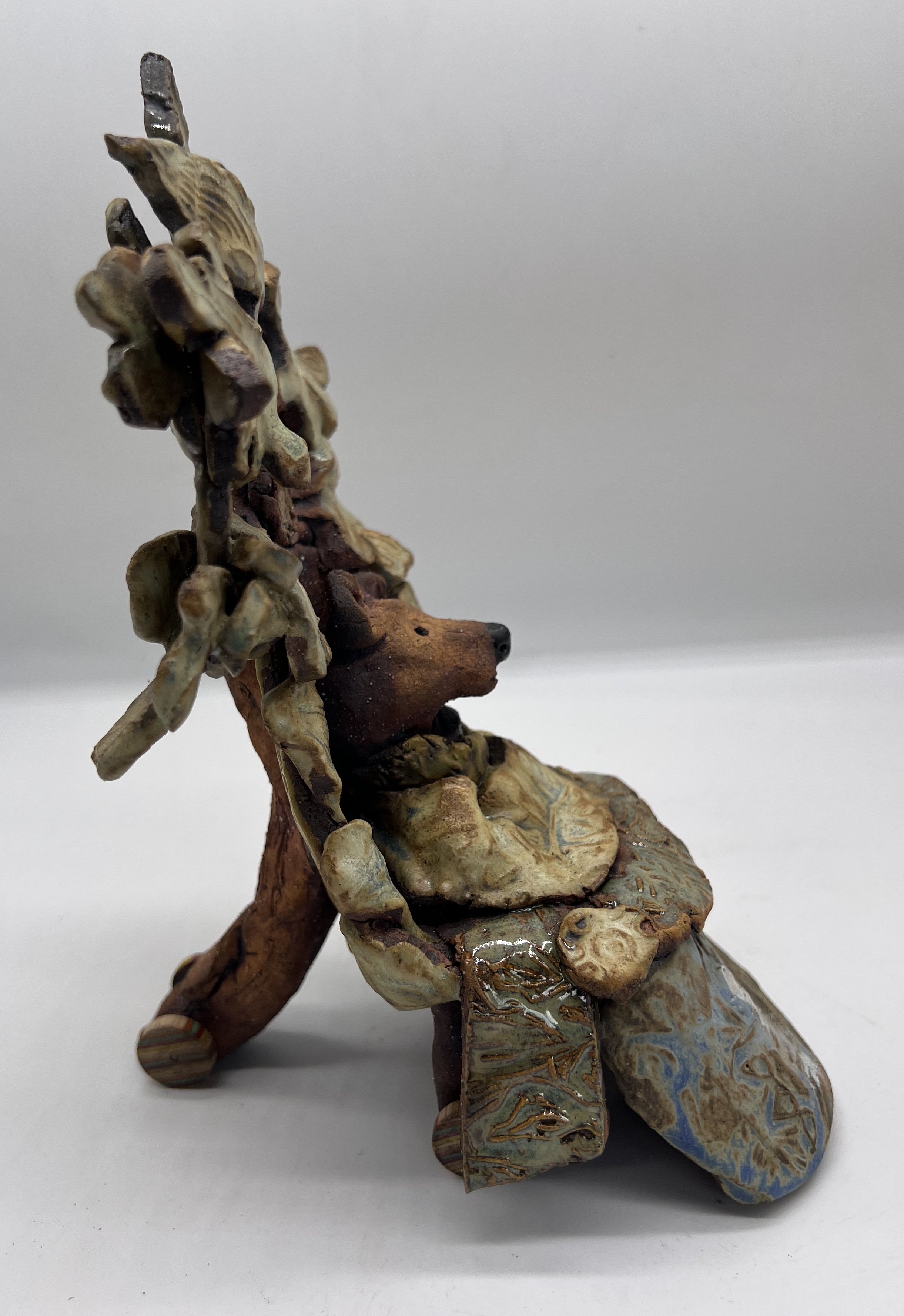 Tomentella. Side View. Ceramic Sculpture. 2025.The Sage Elders. These are the old ones with a comfort blanket and wheelchair. They are the Librarians of all Oak knowledge.