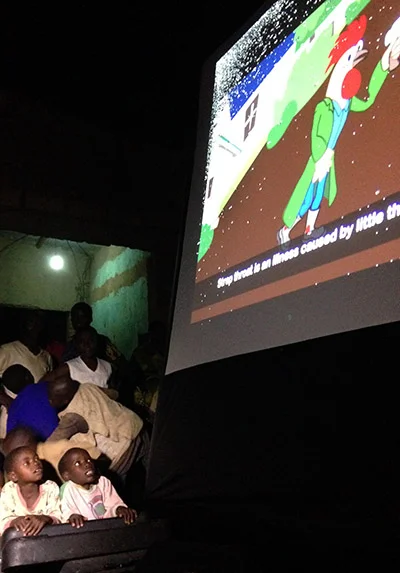 Children watch "Rooster Says: Child Heart Health" at an outdoor screening in Bugesera, Rwanda, on September 10, 2014. Photos by Laura Elizabeth Pohl/ADMA