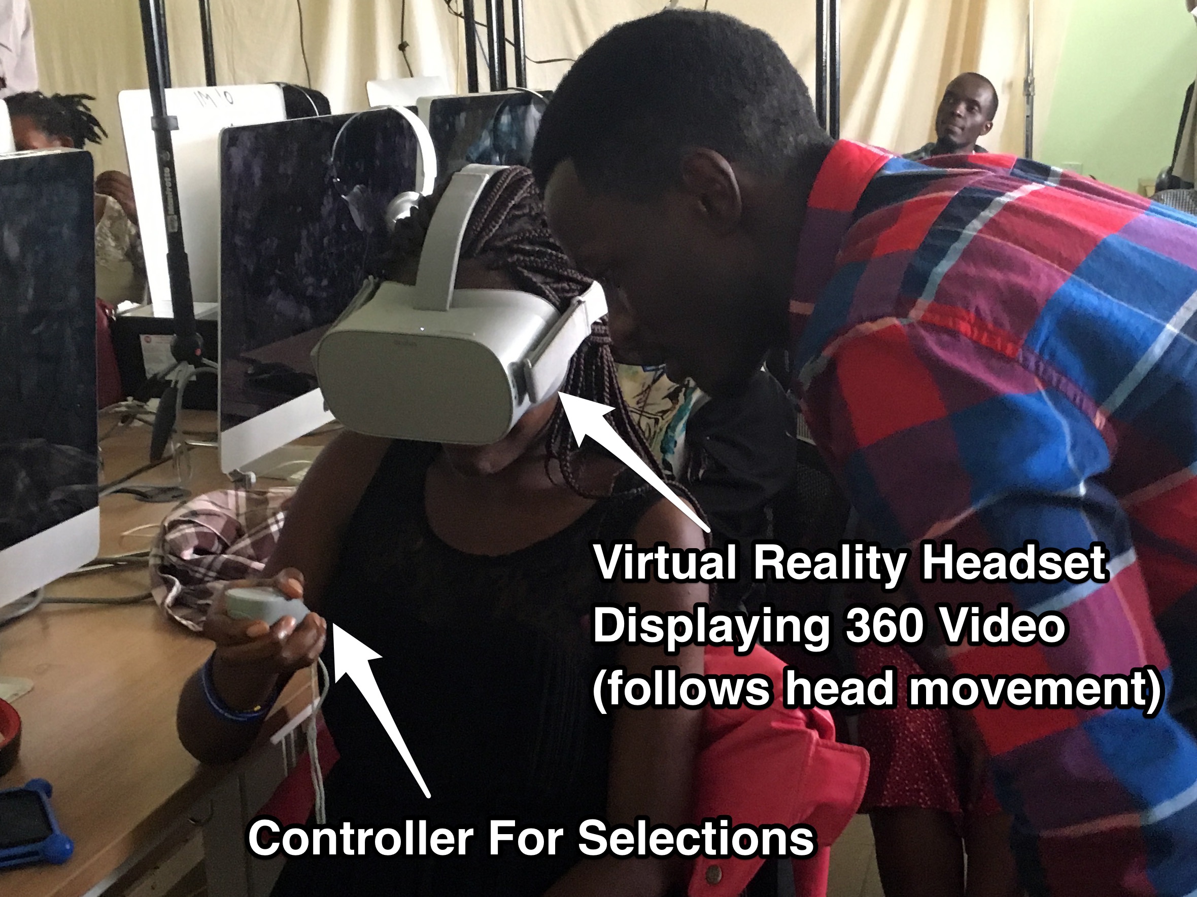 An ADMA student tries out the Oculus Go VR (Virtual Reality) headset with the help of ADMA student.