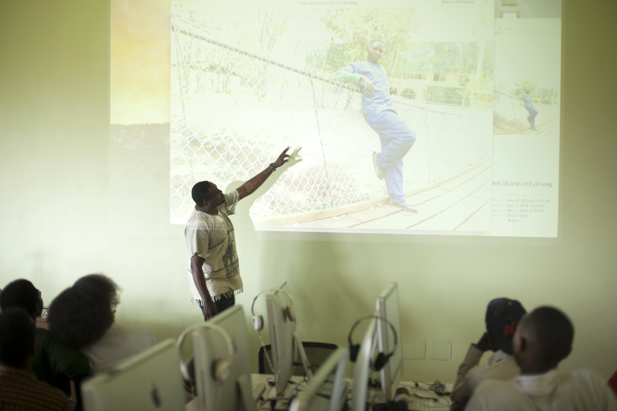 Cyril Ndegeya Giving Feedback On A Student's Photo