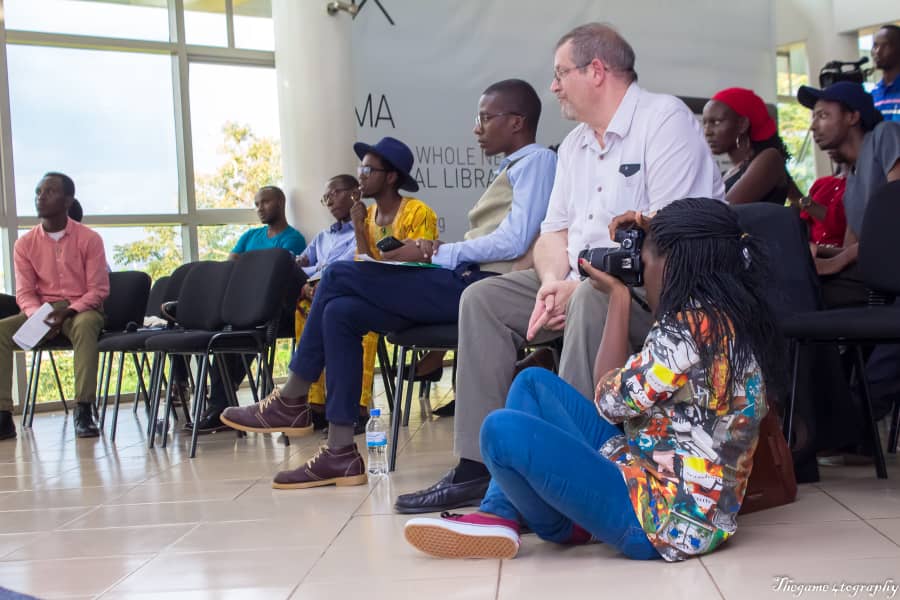 ADMA student Sandrine Iradukunda getting a low angle shot of the event's panel.