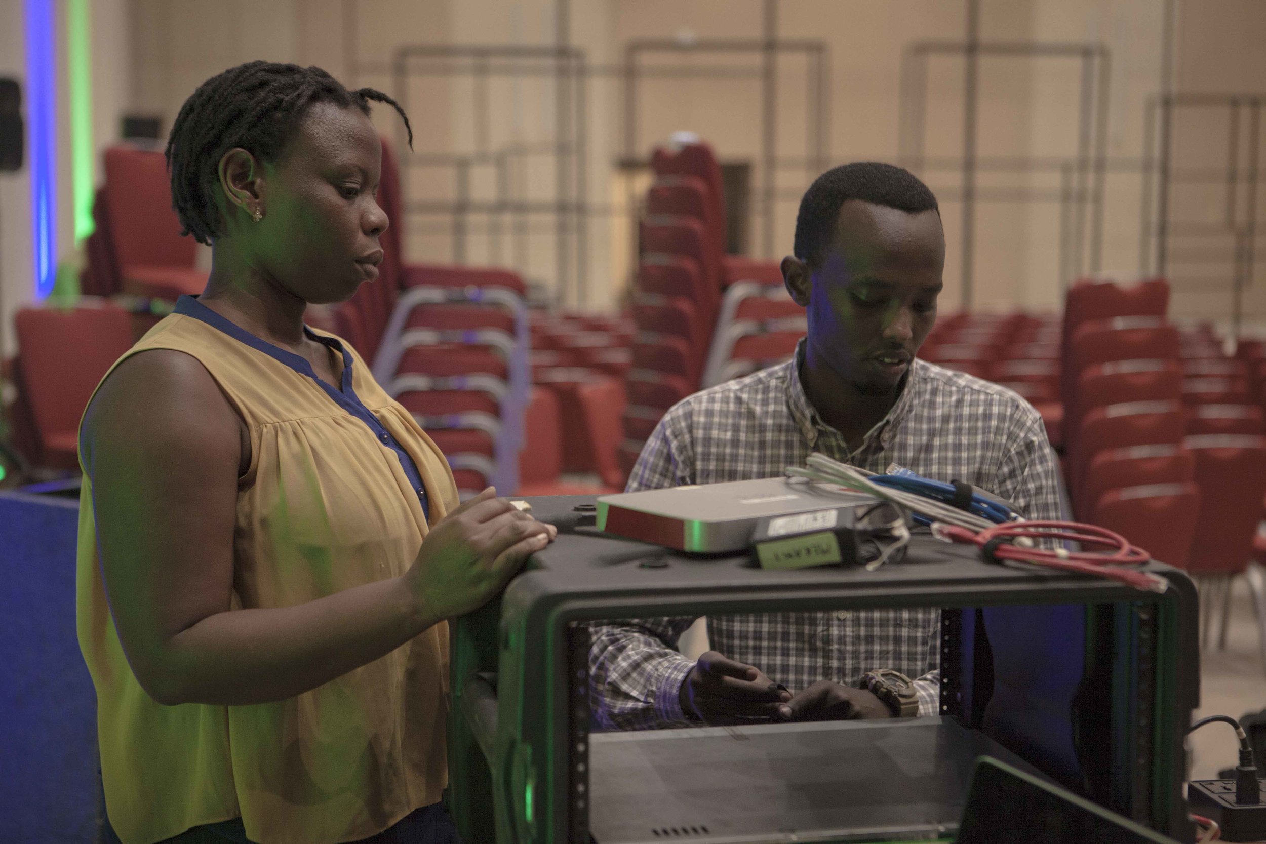 Joselyne Dusabe and Alan Tuyikunde setting up the Cisco Meraki and hardware encoder Elementals that will be used for live streaming purposes