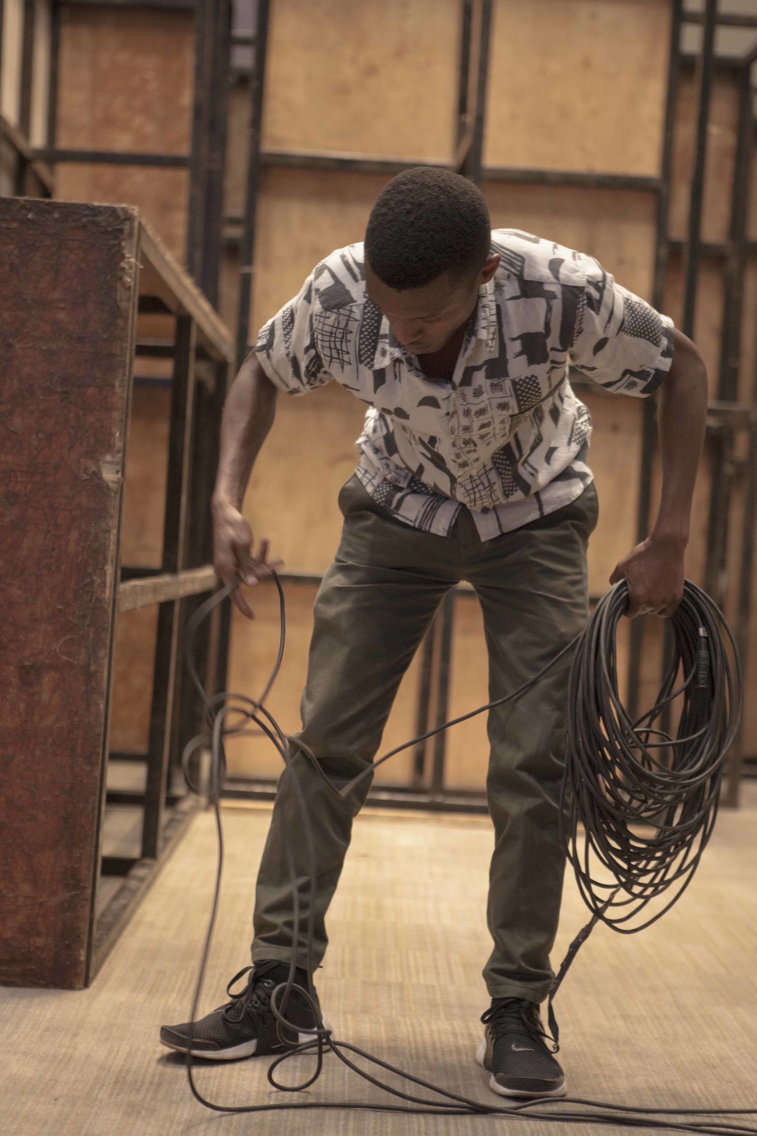 An ADMA volunteer laying one of many SDI cables that will be used to transfer a video feed from the cameras to the switcher