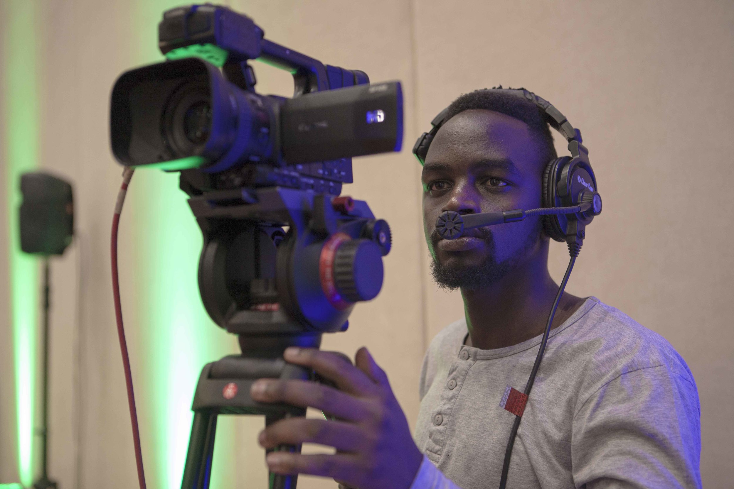 Edgar, one of ADMA students, setting up the Canon XF105, wearing a comms headset to communicate with the technical director